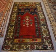 Old Turkish Rug, Decorated with Geometric and Floral Medallions on a Red ground, 175cm x 107cm