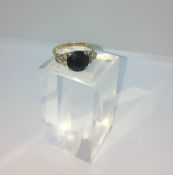 9ct Gold Gemstone and Diamond Ladies Ring, Set with a Dark Stone flanked with three small