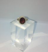 9ct Gold Ruby and Diamond Ladies Cluster Ring, Set with a Ruby Cabochon to the centre, Flanked