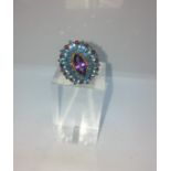 9ct Gold Amethyst and Topaz Ladies Ring, Set with an oval Amethyst Cabochon, Flanked with