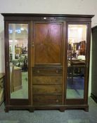 Mahogany Wardrobe, circa early 20th century, Having a Door above four Graduated Drawers, Flanked