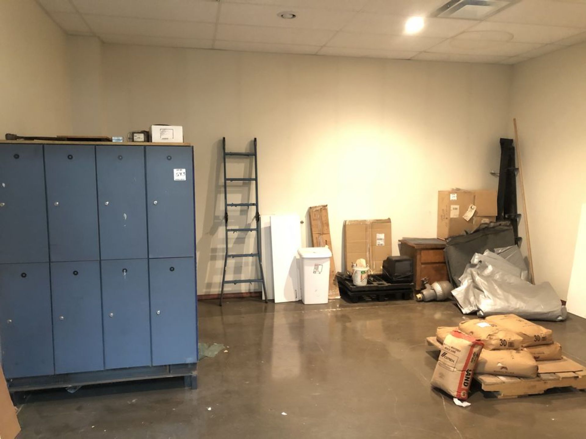 Lot: contents of room- lockers, ladder, bench stand, tarp, desk
