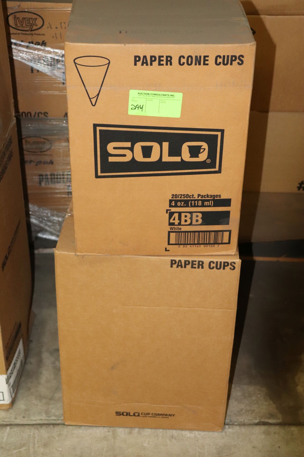 Two boxes of paper cups and paper cone cups