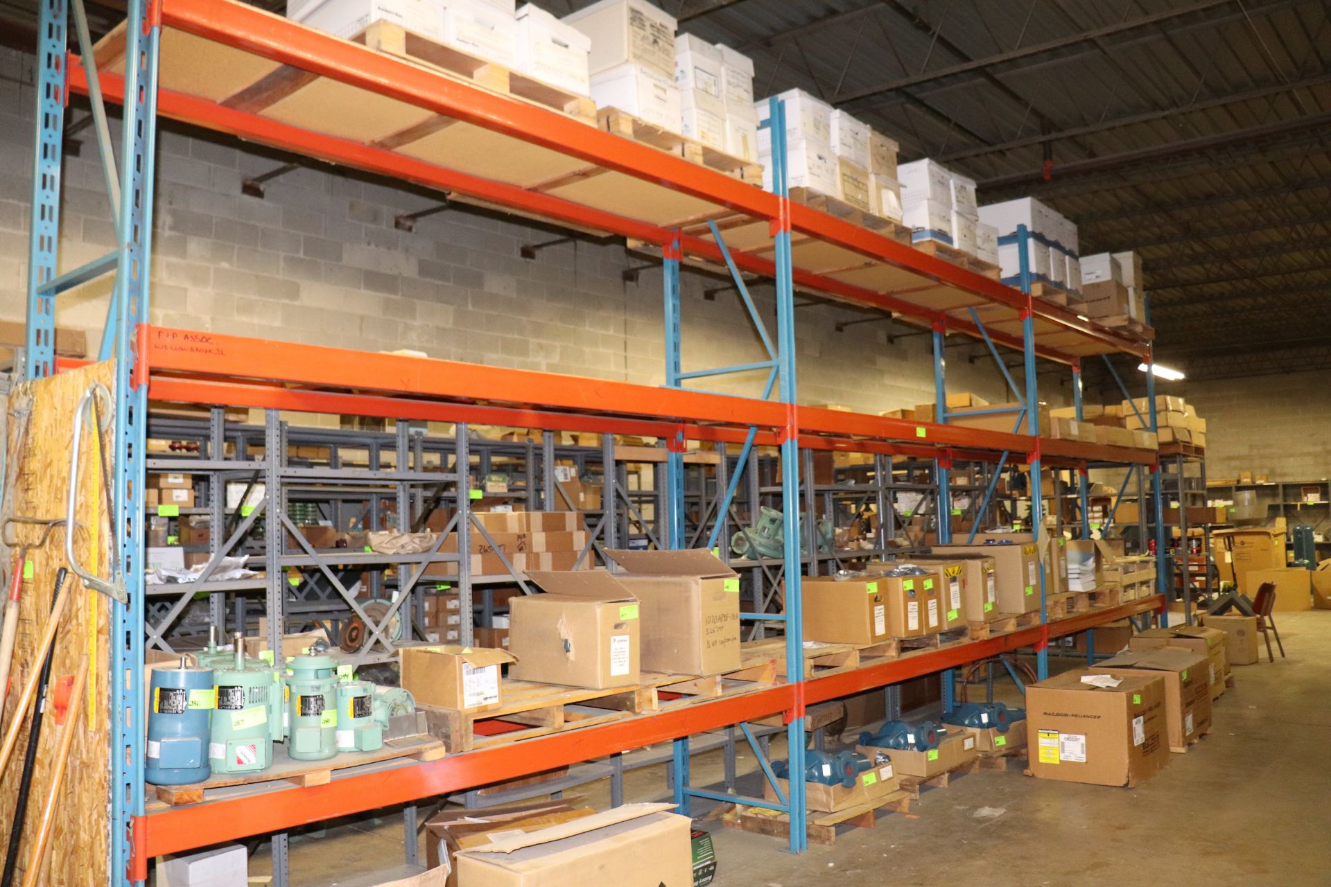 Three sections of pallet racking, marked for late removal