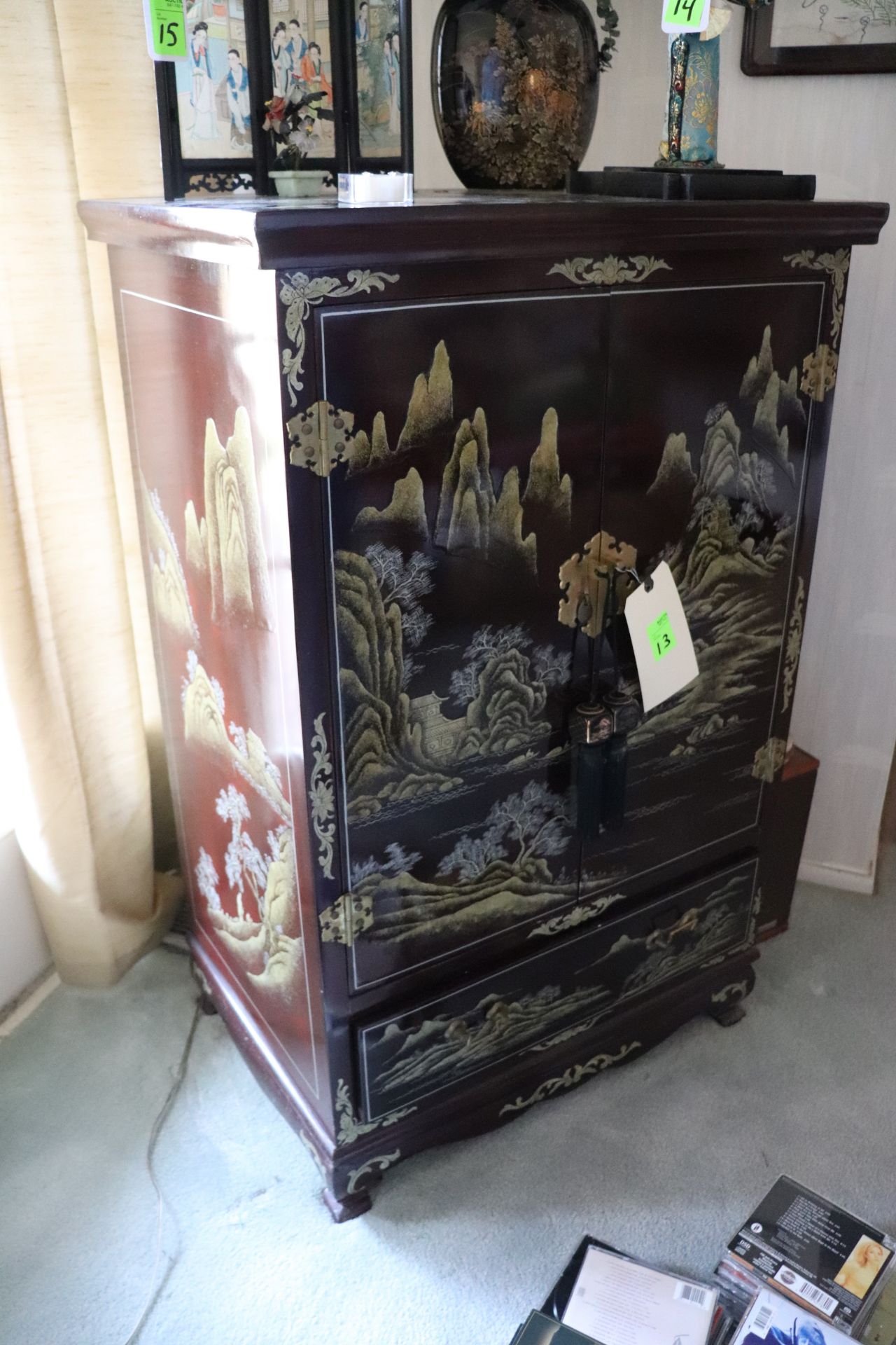 Painted Chinese entertainment center with one drawer and two doors, black lacquer