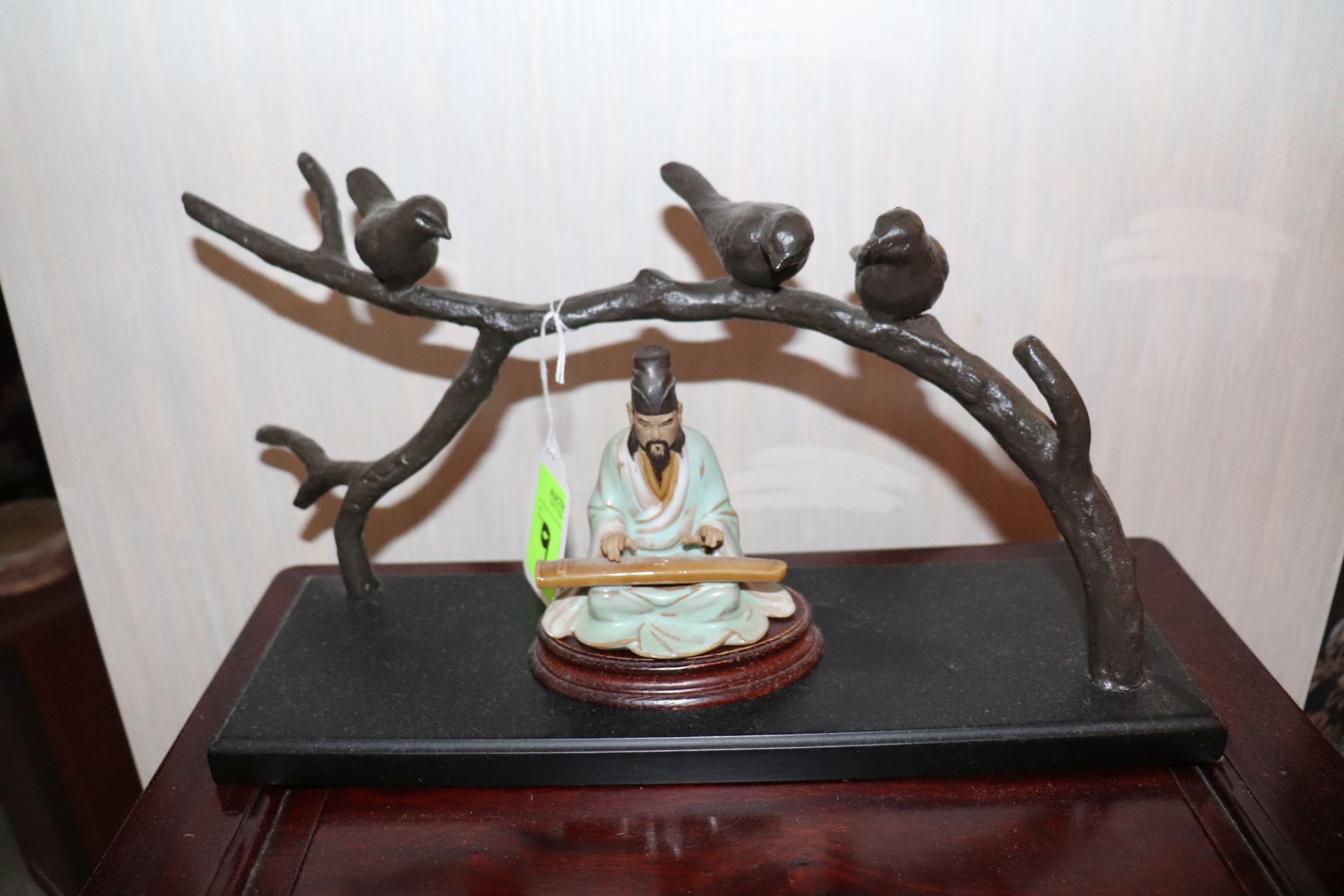 Oriental figurine and a bird sculpture