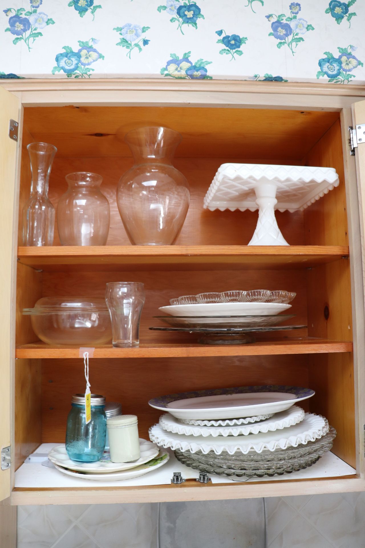 Everything pictured in cabinet, milk glass and glassware