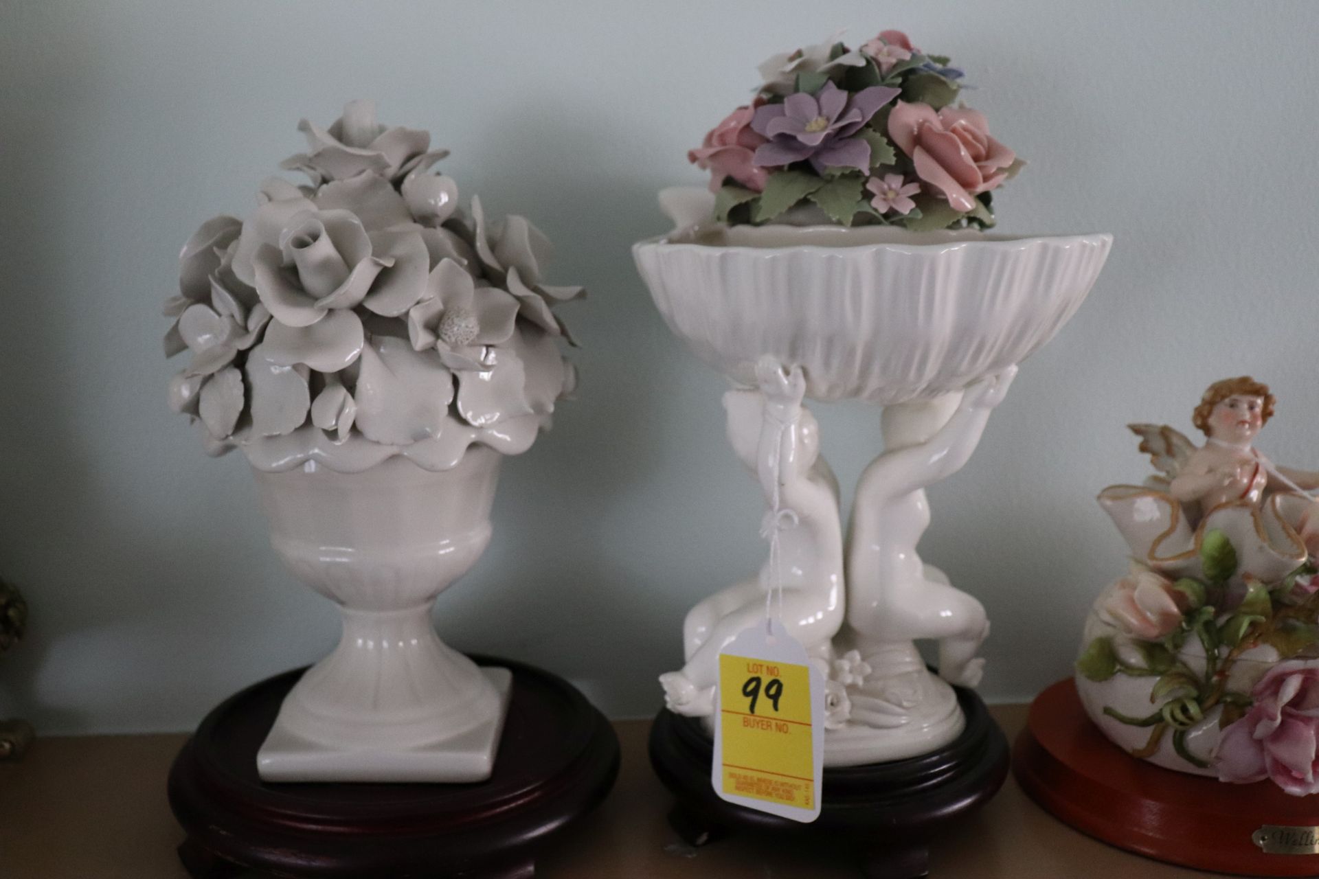 Two pieces: floral urn and a Putti form compote, approximate height 11" and 12"