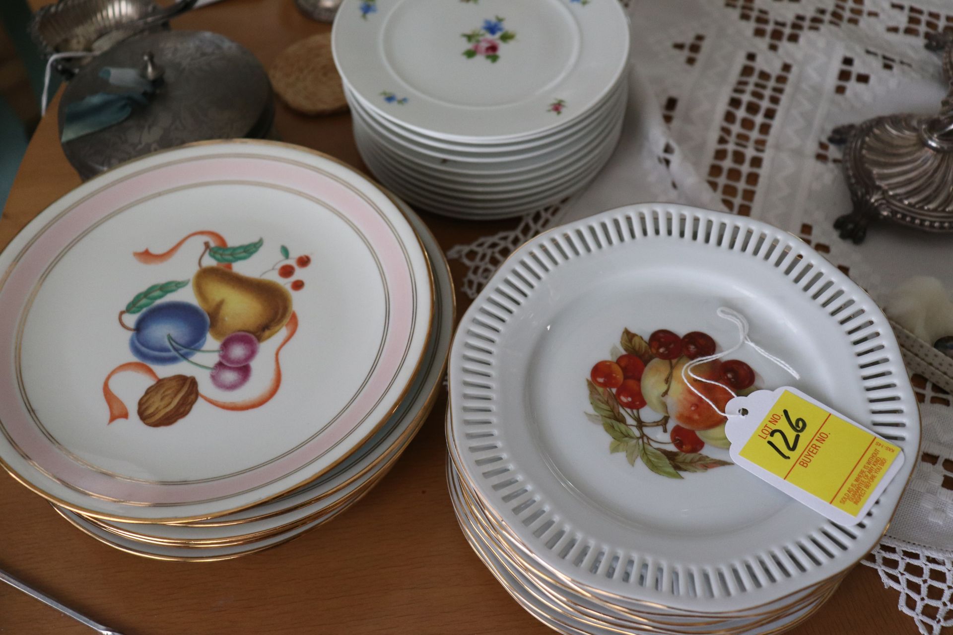 Group of dishware with floral and fruit pattern