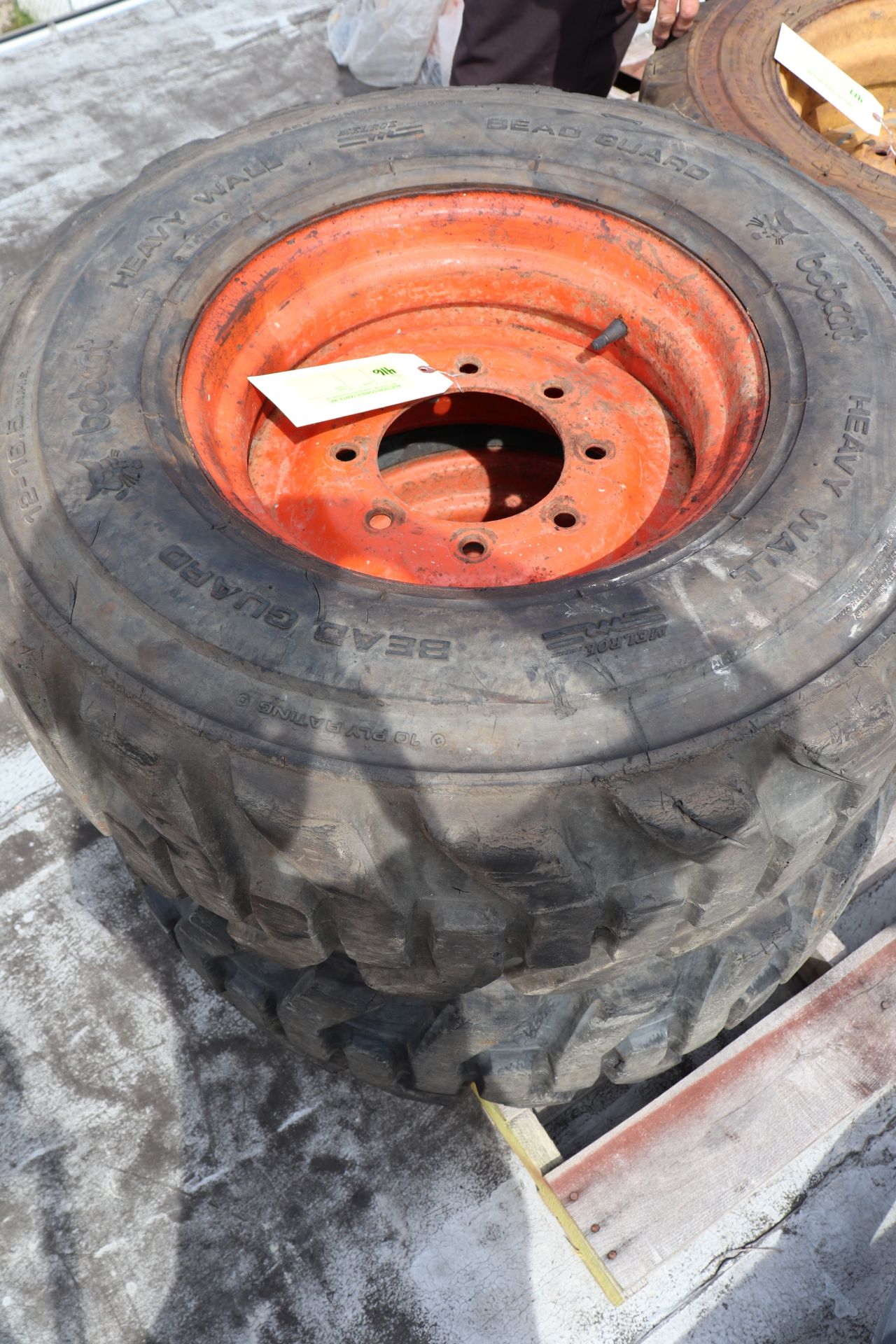 Two skid steer tires and rims