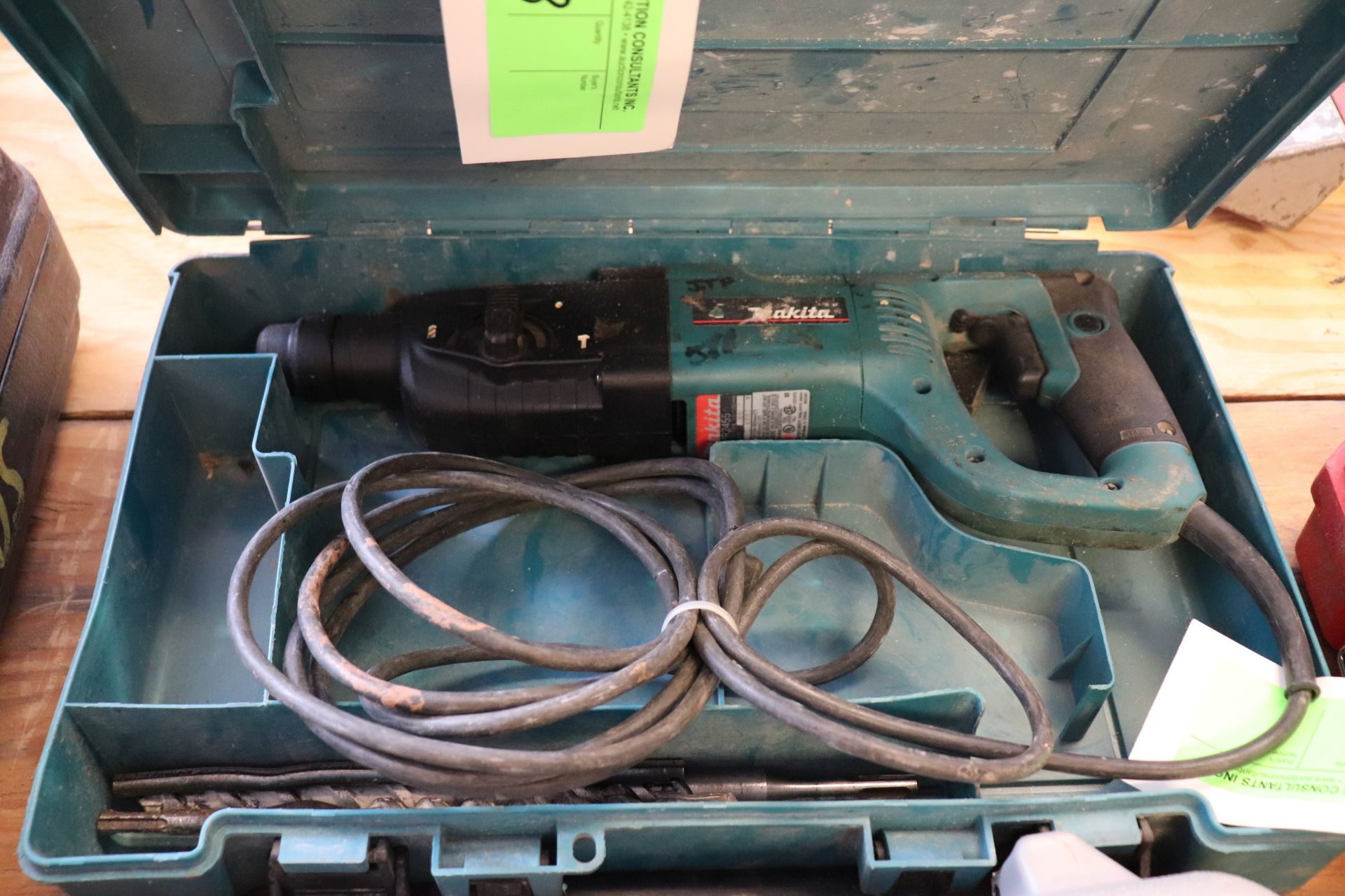 Makita model HR2455 hammer drill with bits and case, electric