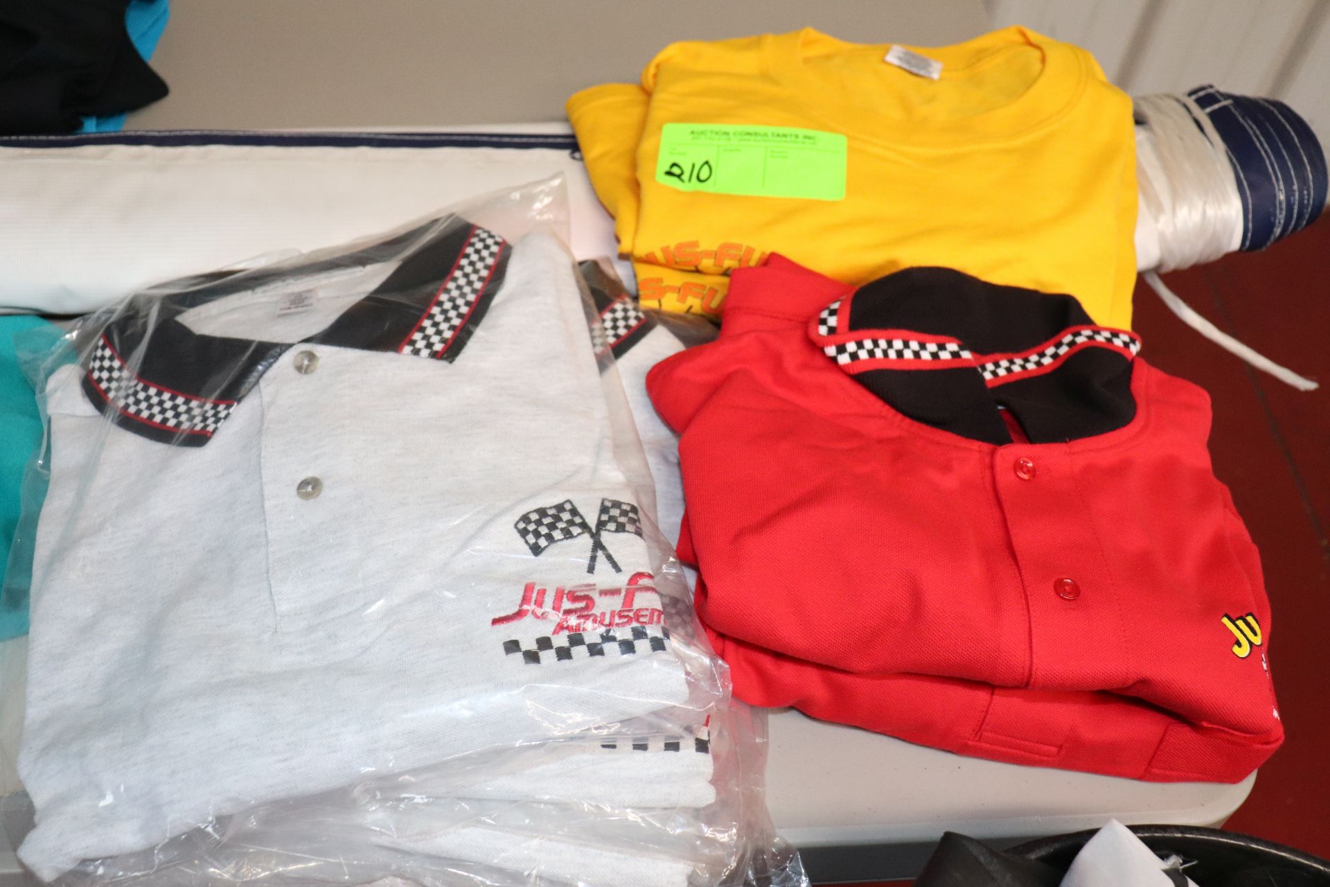 Two 2XL yellow JusFun T-shirts, four JusFun extra large gray polos, and two red extra large polos