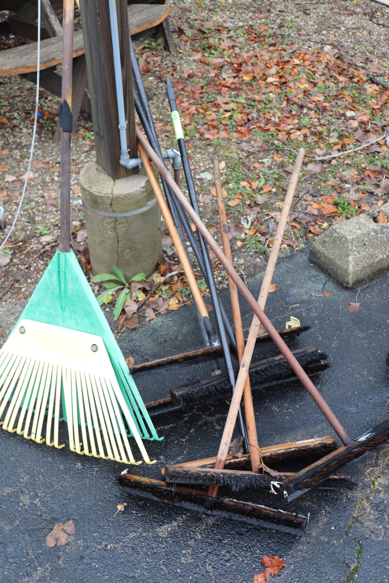 Lot of hand tools including rake and tar brushes