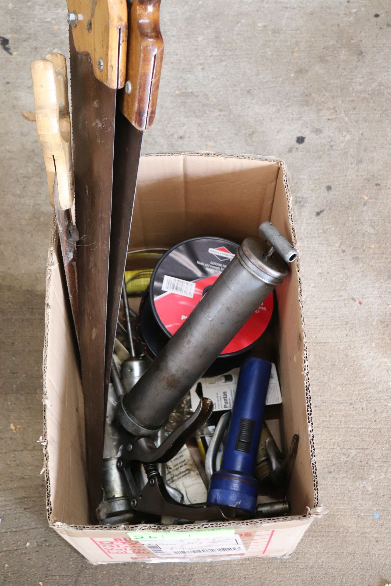 Box lot of grease guns, hand saws, premium nylon starter rope, and other miscellaneous