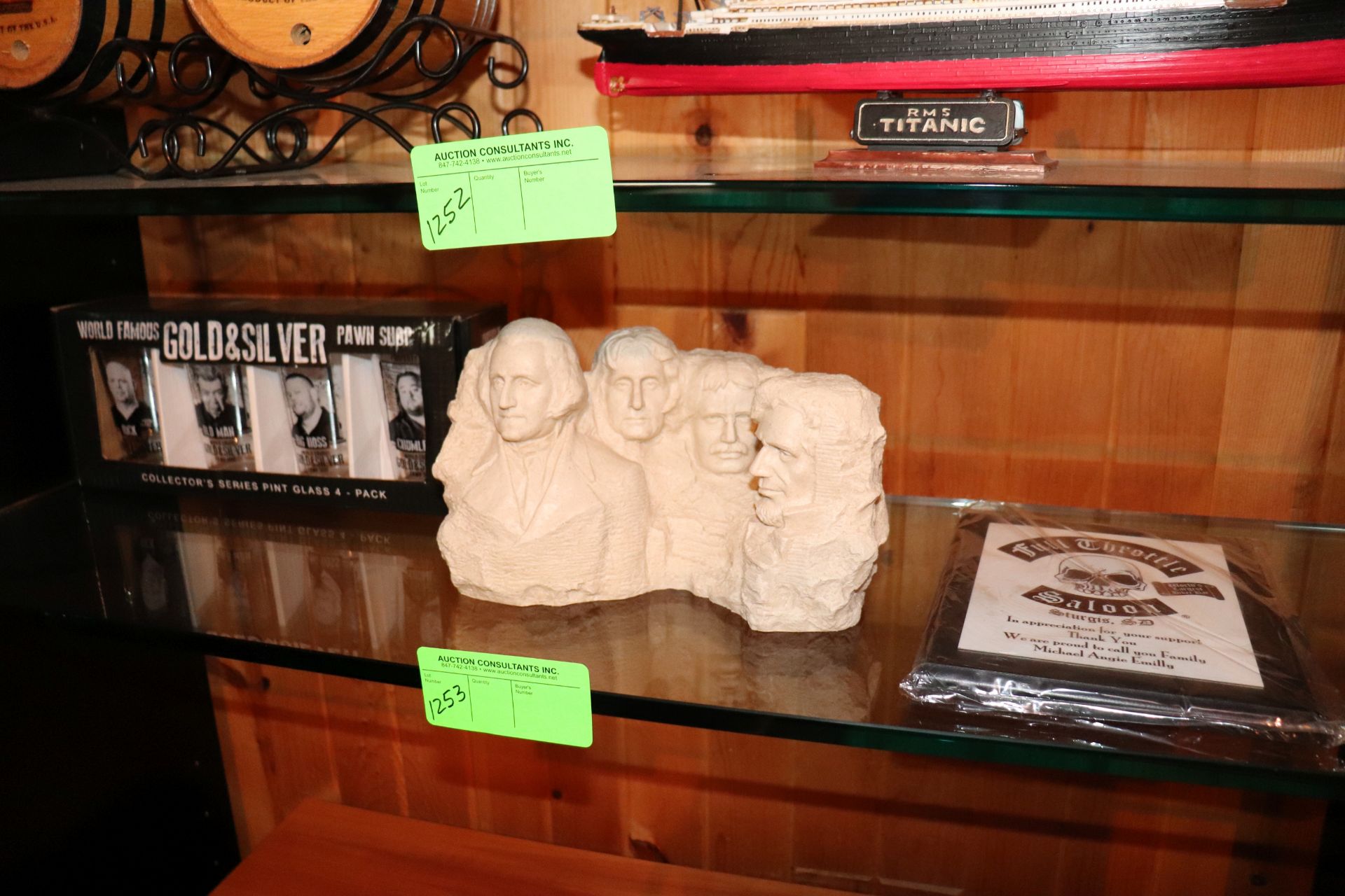 Pawn Shop Show commemorative pint glasses, model of Mt Rushmore, and a Full Throttle Saloon plaque