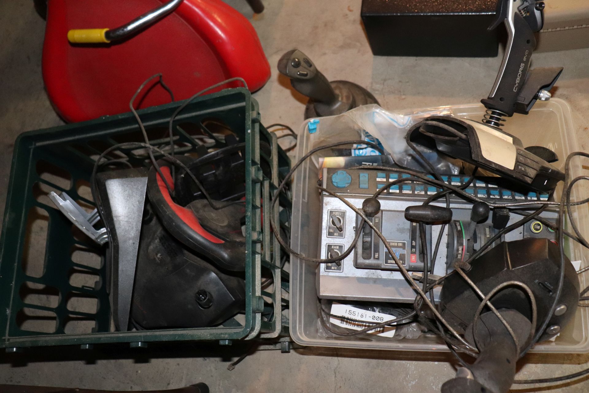 Two bins of joysticks including Cyborg Evo, MicroSoft flight stick, Logitech Wingman and other misce