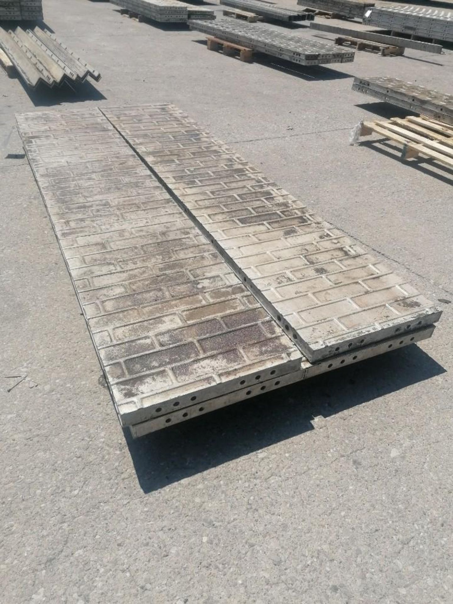 (4) 22" x 9' Wall-Ties Aluminum Concrete Forms, Smooth Brick 6-12 Hole Pattern. Located at 301 E