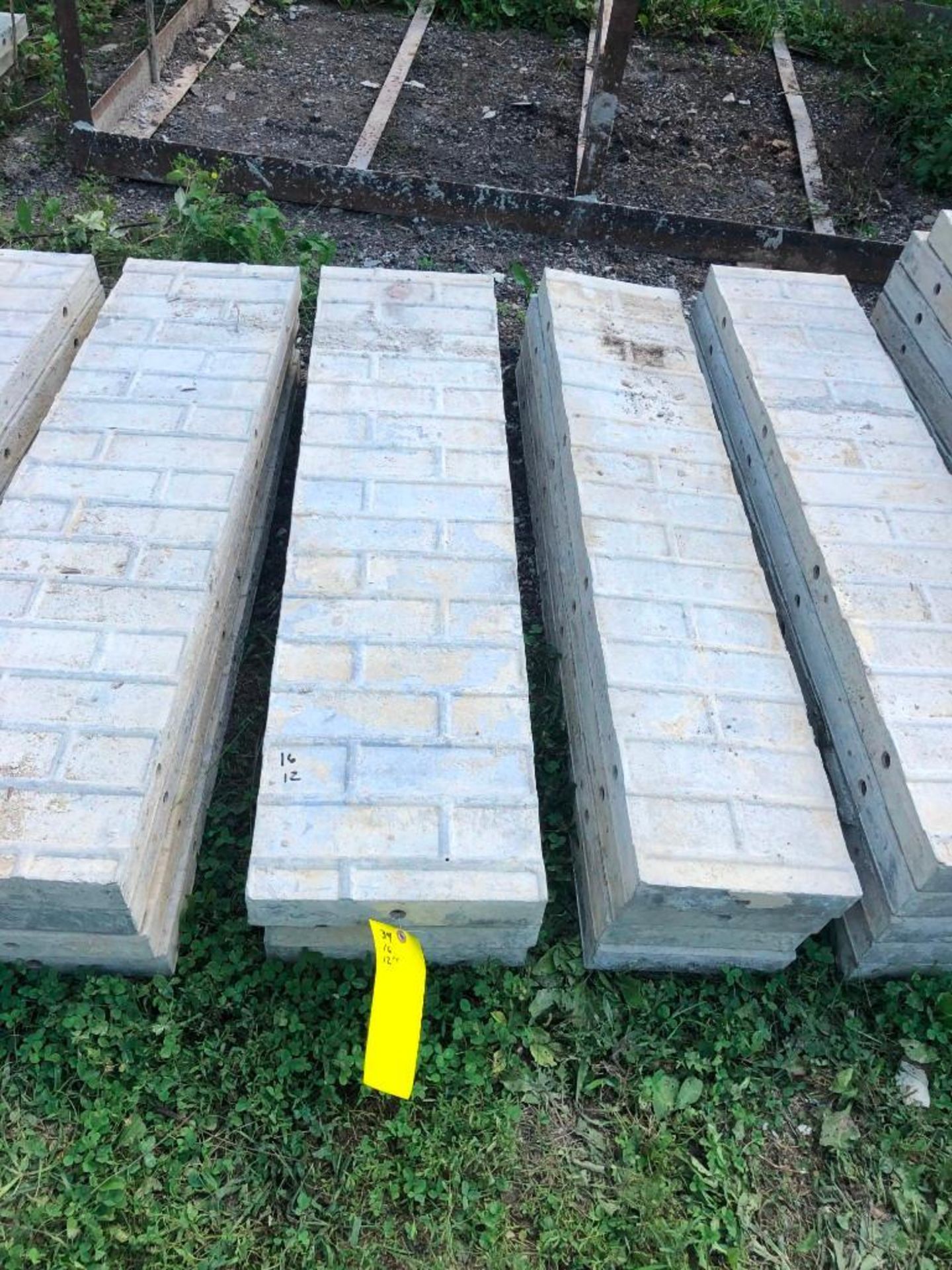 (16) 12" x 4' Symons Aluminum Concrete Forms, Smooth Brick 6-12 Hole Pattern. Located at 2086 E US