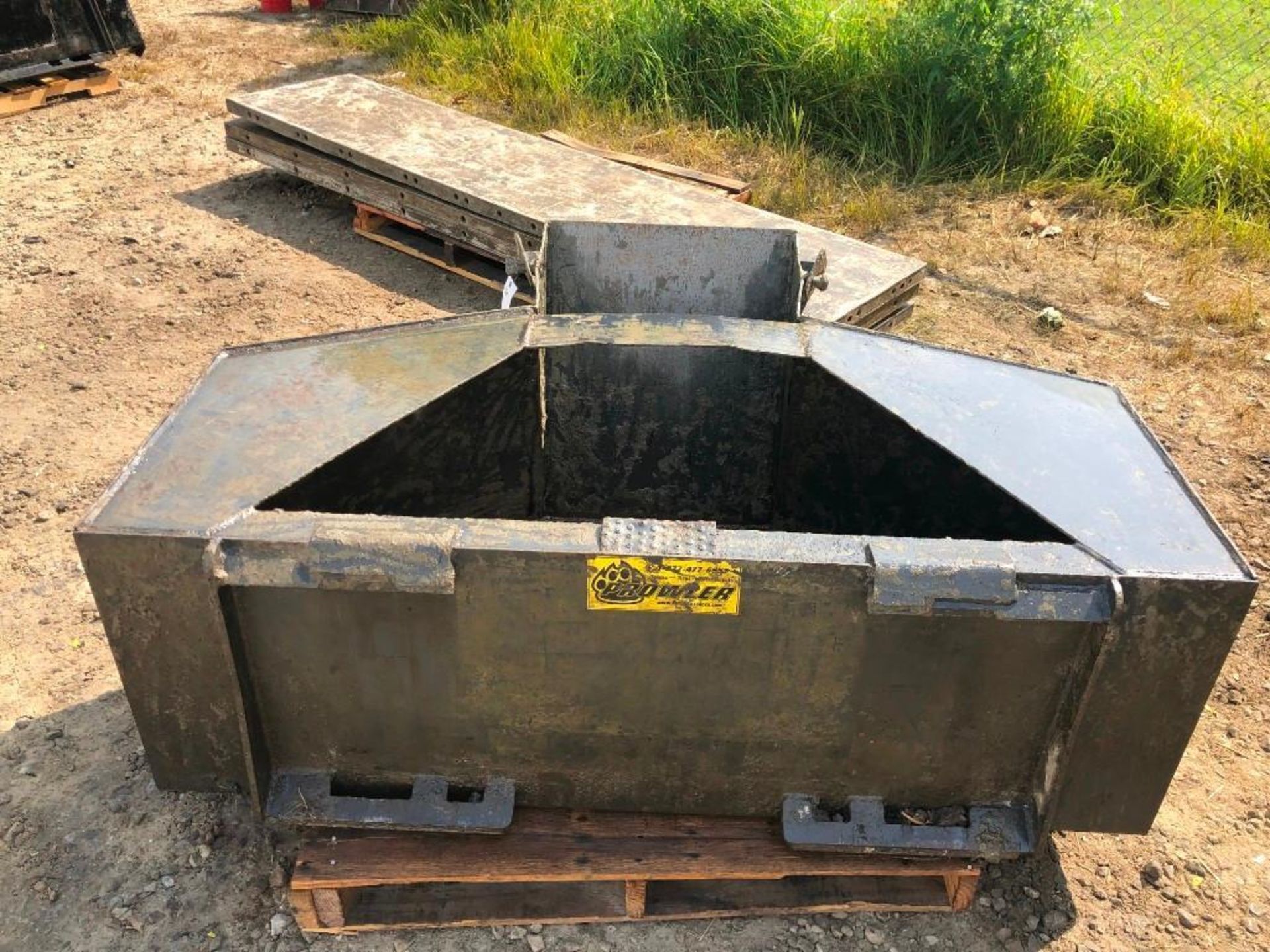 Skidloader Concrete Chute Bucket. Located at 301 E Henry Street, Mt. Pleasant, IA 52641.