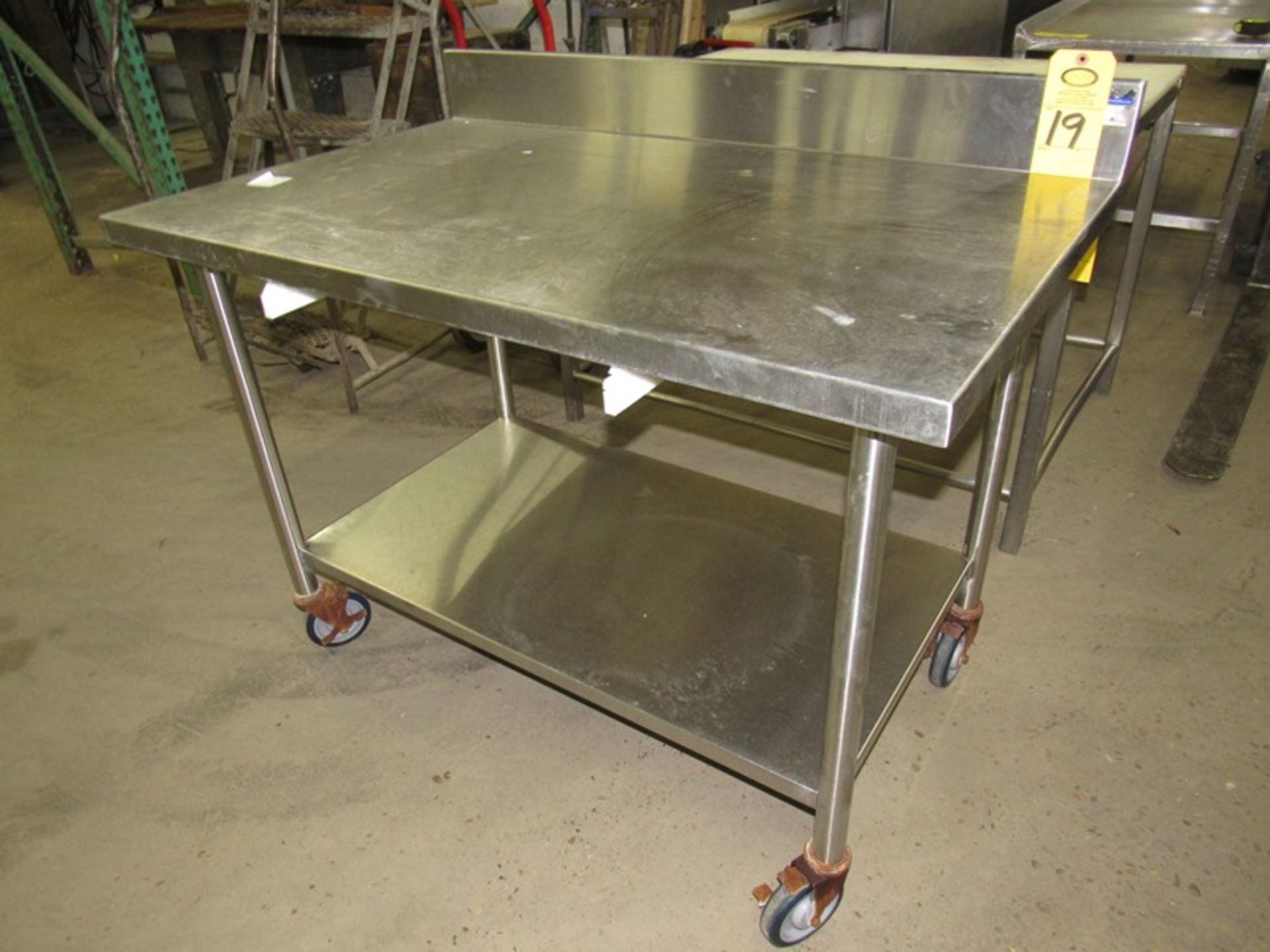 Stainless Steel Table, 30" W X 48" L X 35" T, 5" backsplash, bottom shelf on casters, space for