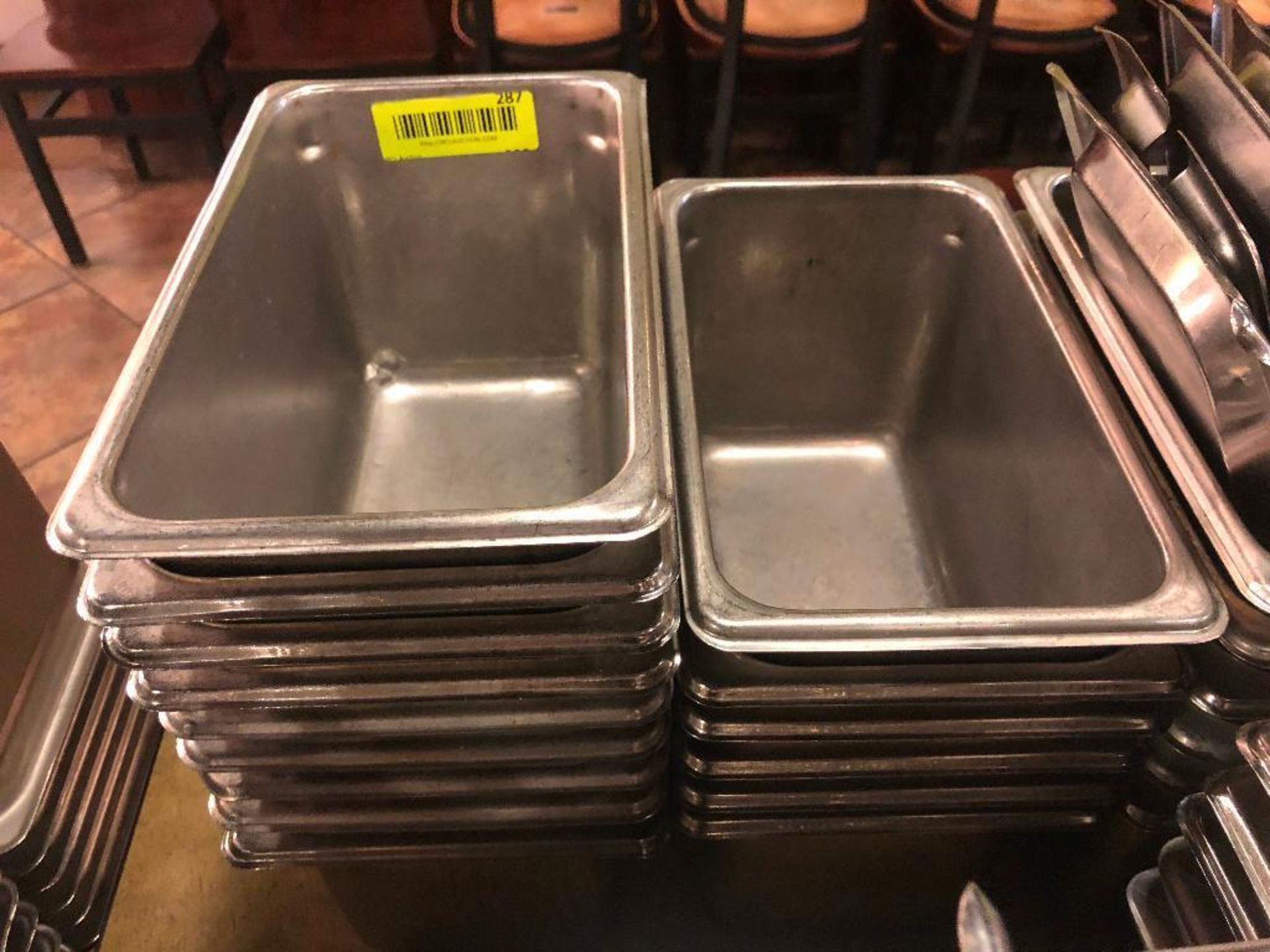 DESCRIPTION: (12) 1/4 SIZE STAINLESS INSERTS. NO LIDS SIZE: 6" DEEP LOCATION: MAIN SEATING THIS LOT