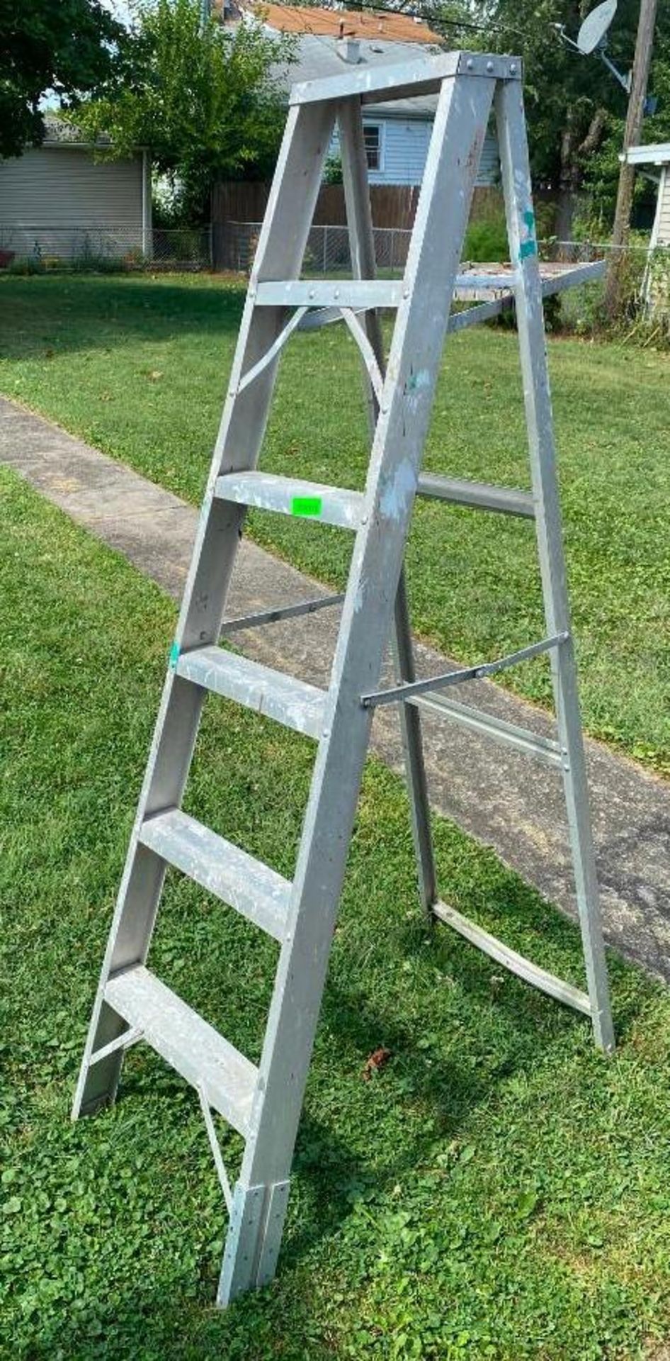 DESCRIPTION 6' ALUMINUM STEP LADDER LOCATION BACKYARD QUANTITY: X BID 1