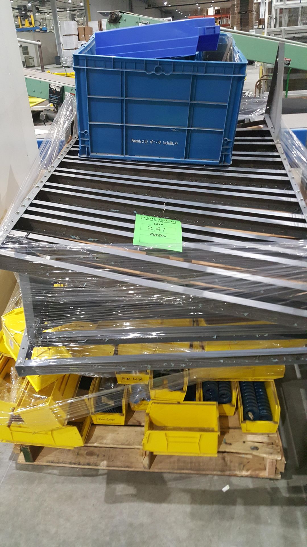 Flow rack on wheels, with a pallet of yellow bins