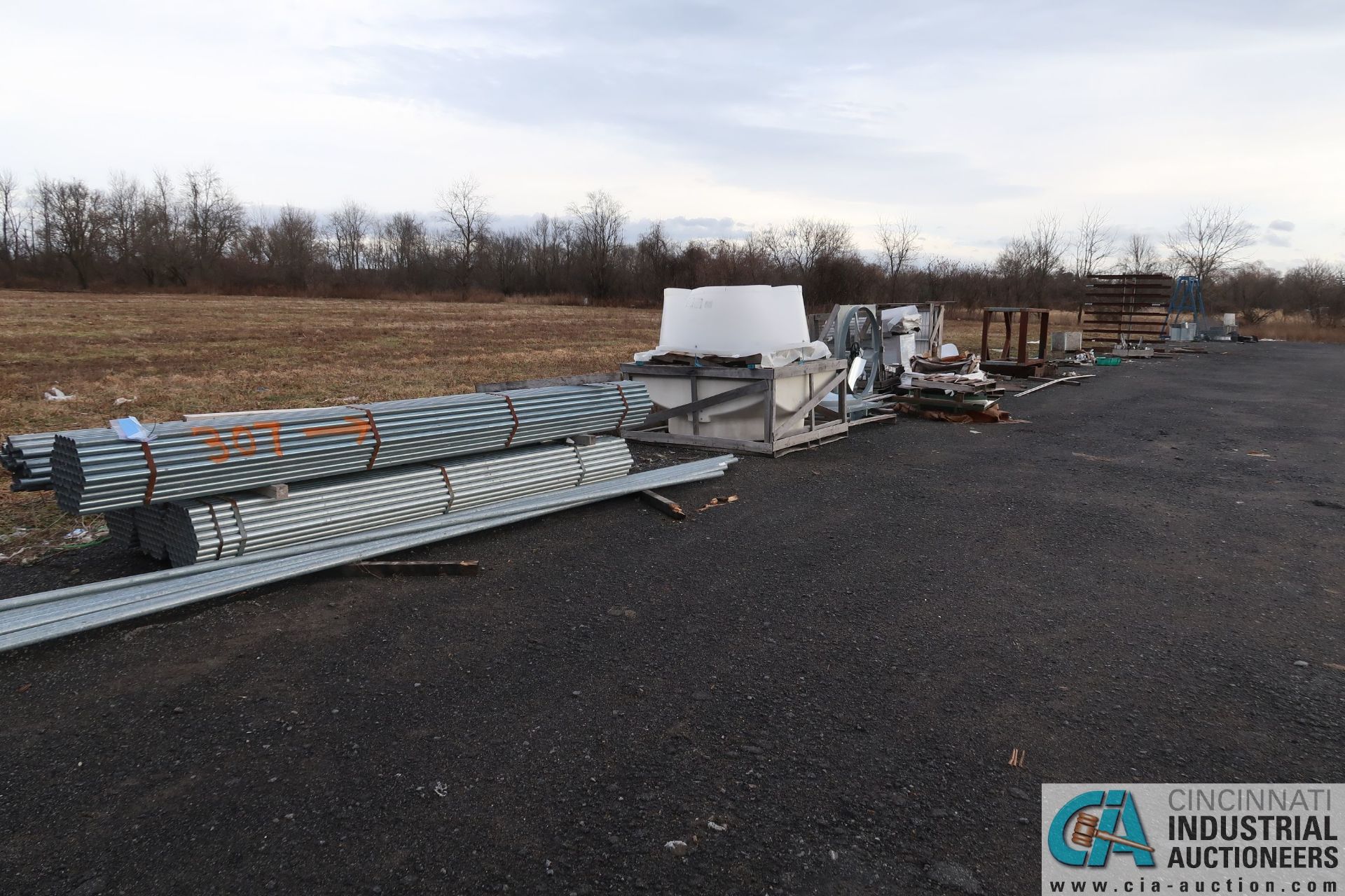 (LOT) BALANCE OF RAW MATERIAL AND FABRICATED PARTS AT BACK OF LOT AND UP TO AND AROUND TRAILERS **