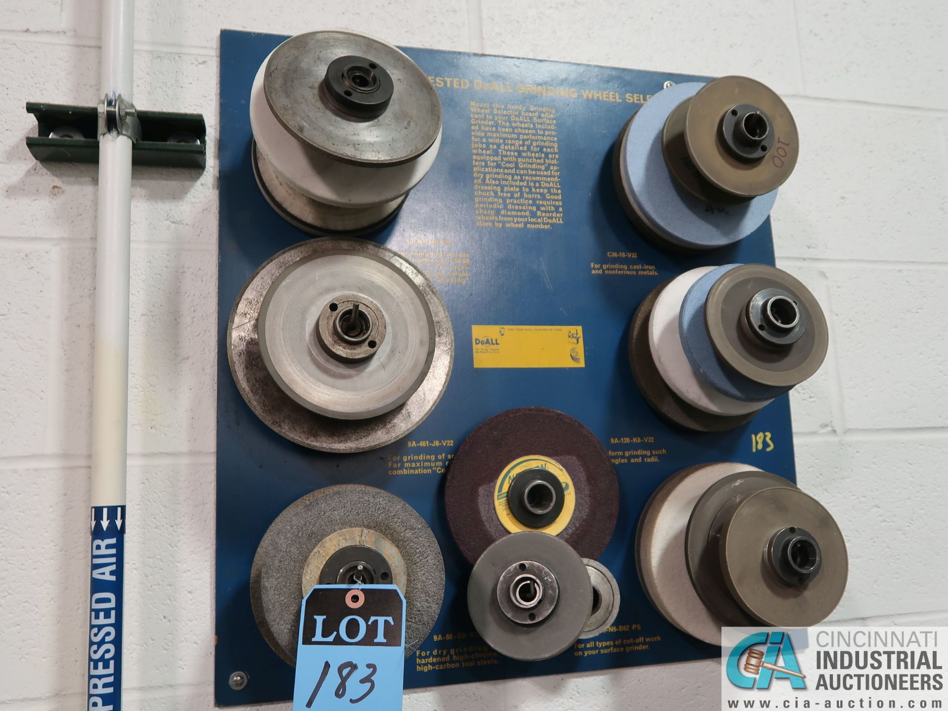 (LOT) GRINDING WHEELS ON WALL RACK WITH SPINDLE ARBORS