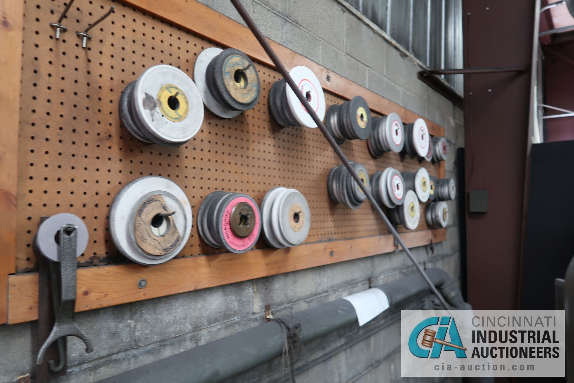 (LOT) MISCELLANEOUS GRINDING WHEELS ON WALL AND BENCH **PEGBOARD STAYS WITH BUILDING** - Image 2 of 7