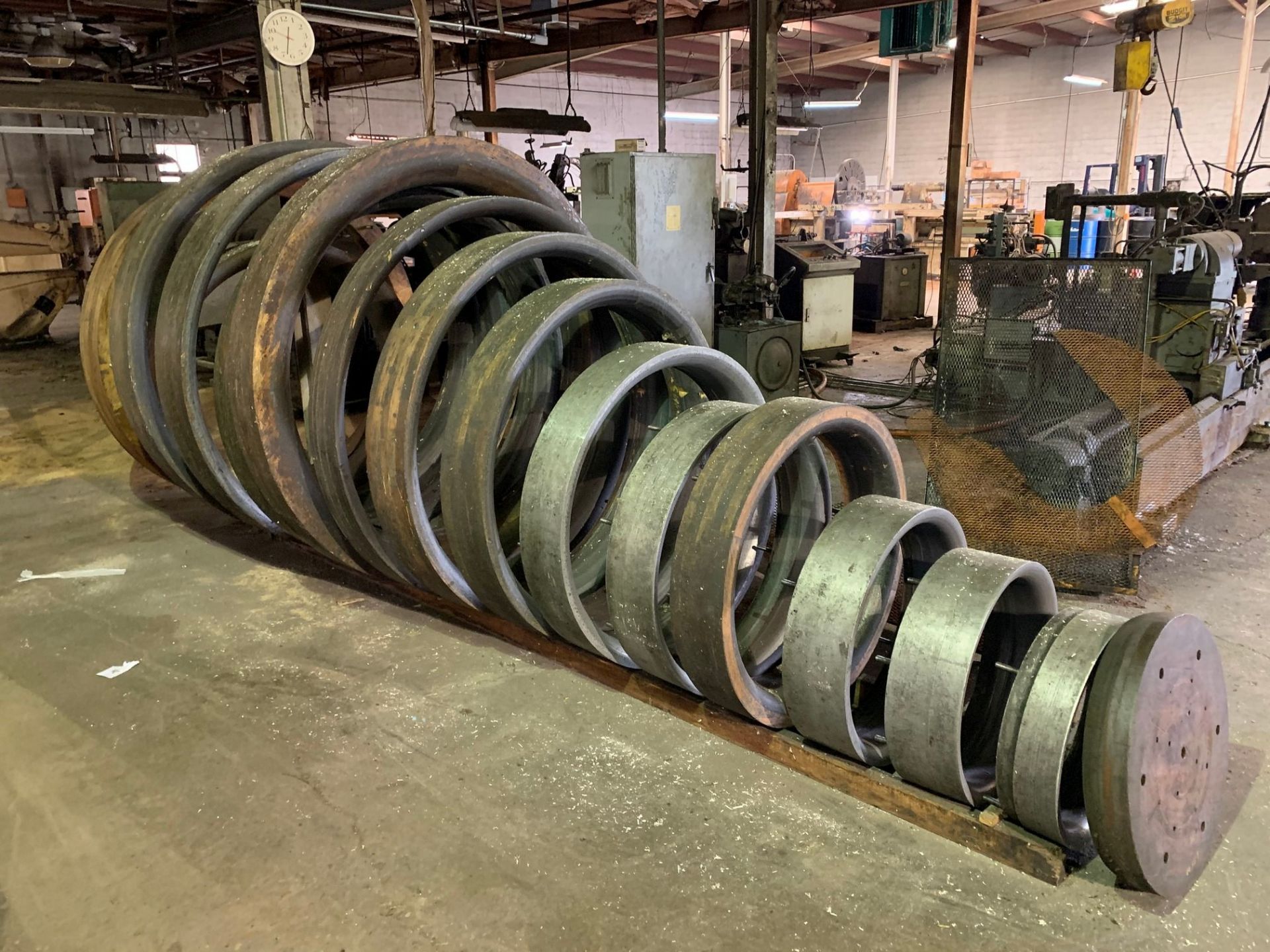 (LOT) APPROX. (70) WOOD AND STEEL CIRCULAR FORMING DIES, FROM 12" - 84" DIAMETER WITH RACKS