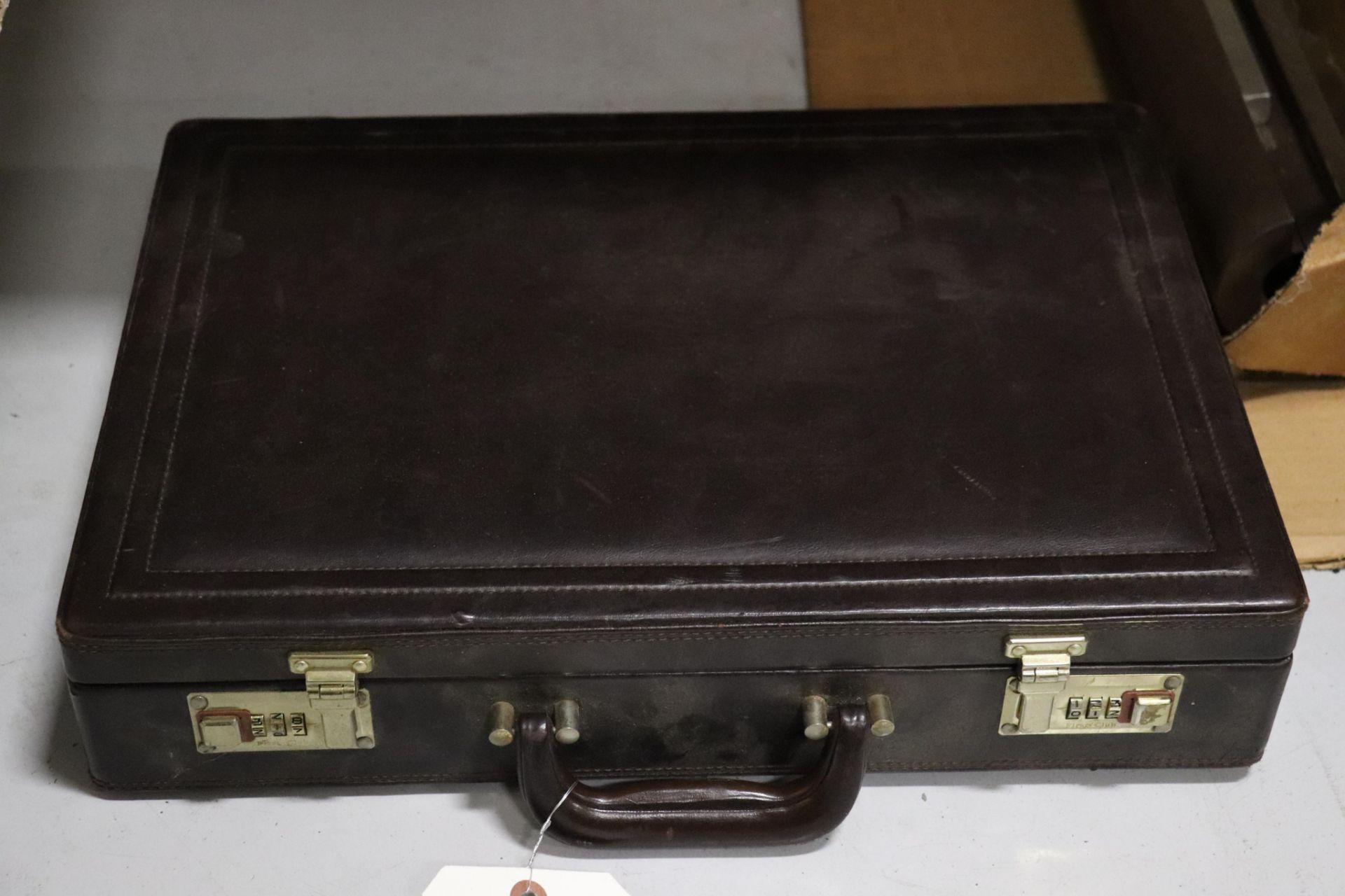 Brief case, locked; do not have the code, contents unknown