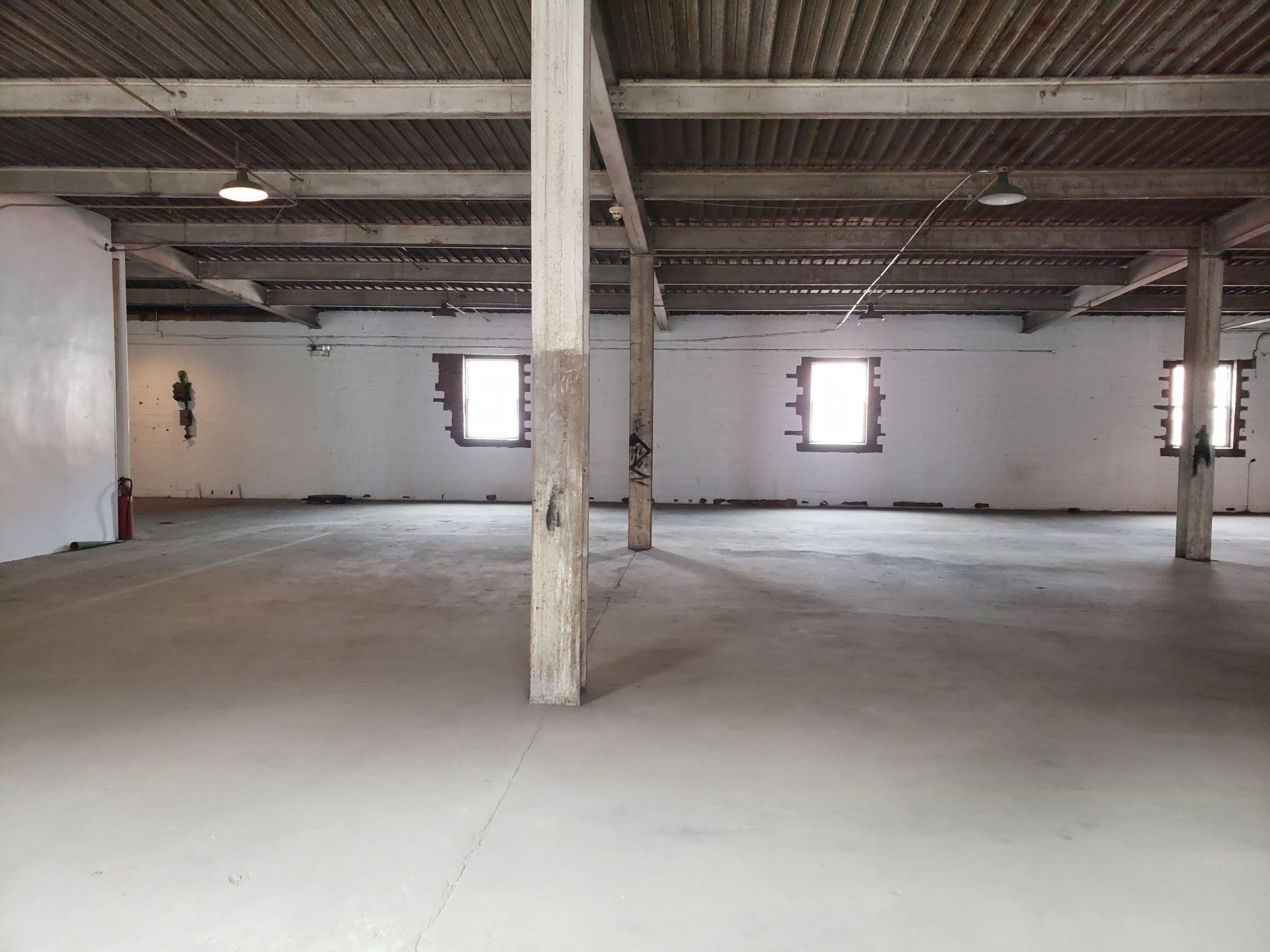 =/- 30,000 SF three story building with truck access, rail runs next to building - Image 49 of 58