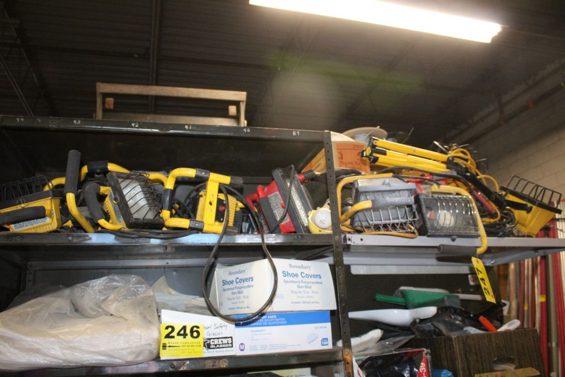 LARGE ASSORTMENT OF PORTABLE WORK LIGHTS ON TWO SHELVES