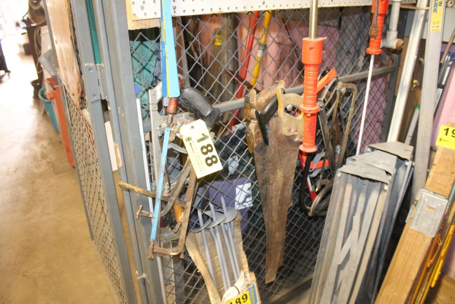 ASSORTED SAWS HANGING ON HOOKS