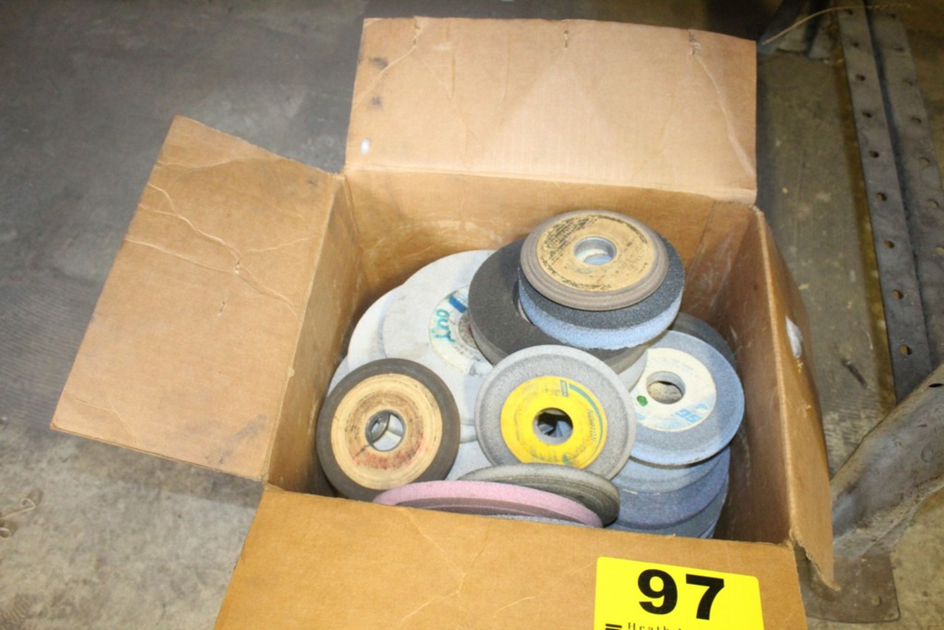 LARGE QTY OF GRINDING WHEELS UNDER BENCH