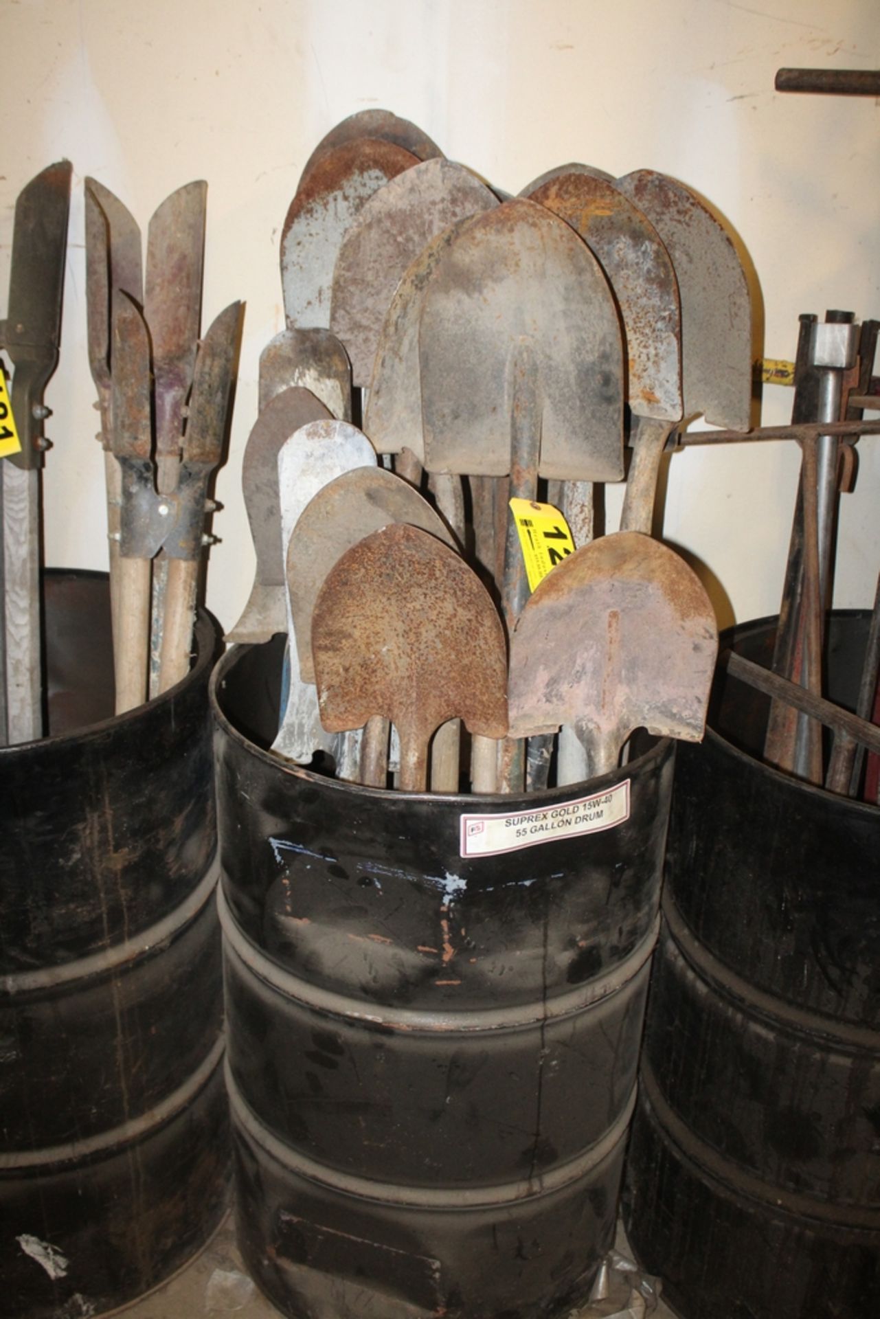 LARGE QTY OF SHOVELS IN DRUM WITH DRUM