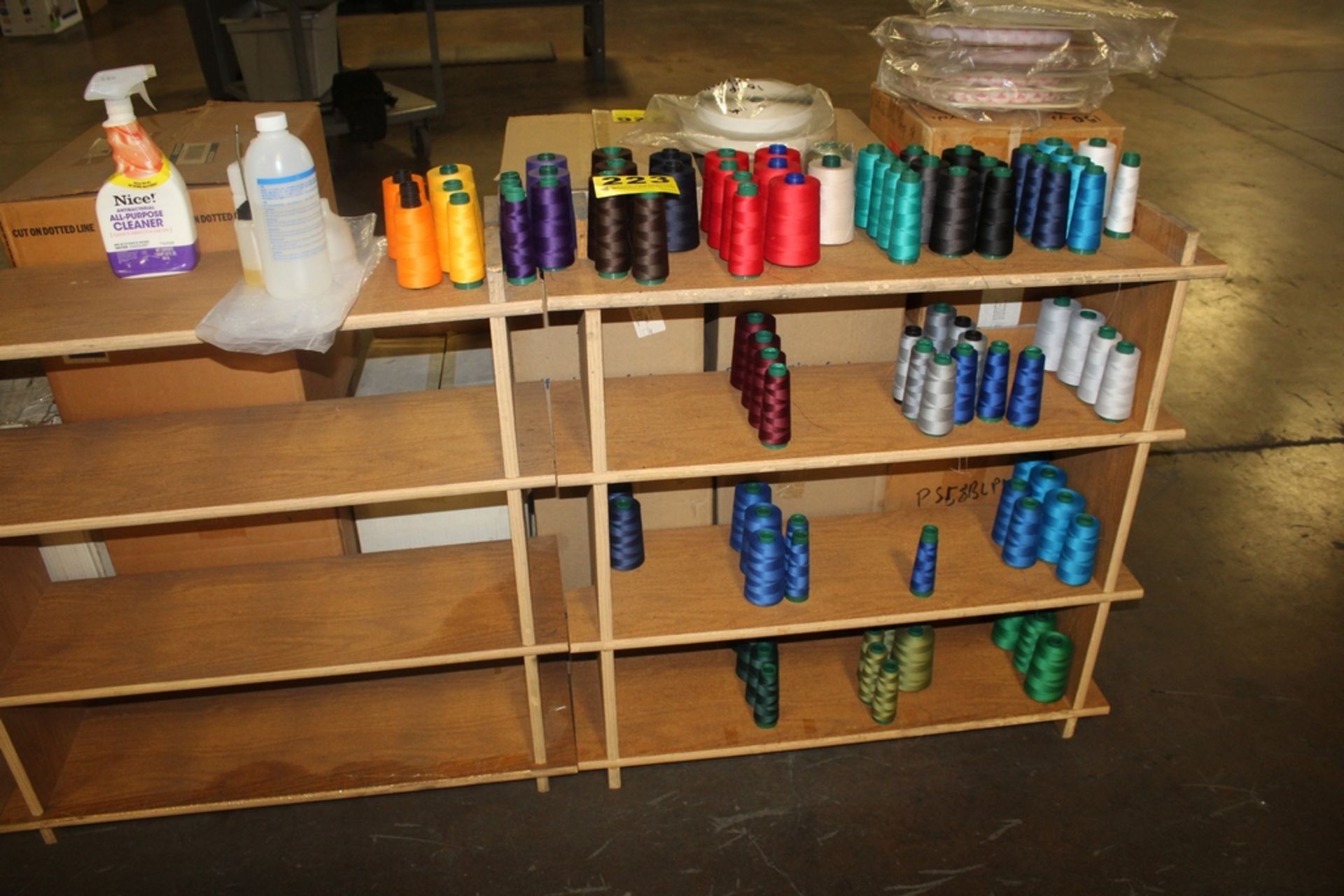 LARGE QTY OF THREAD SPOOLS ON SHELF WITH SHELF