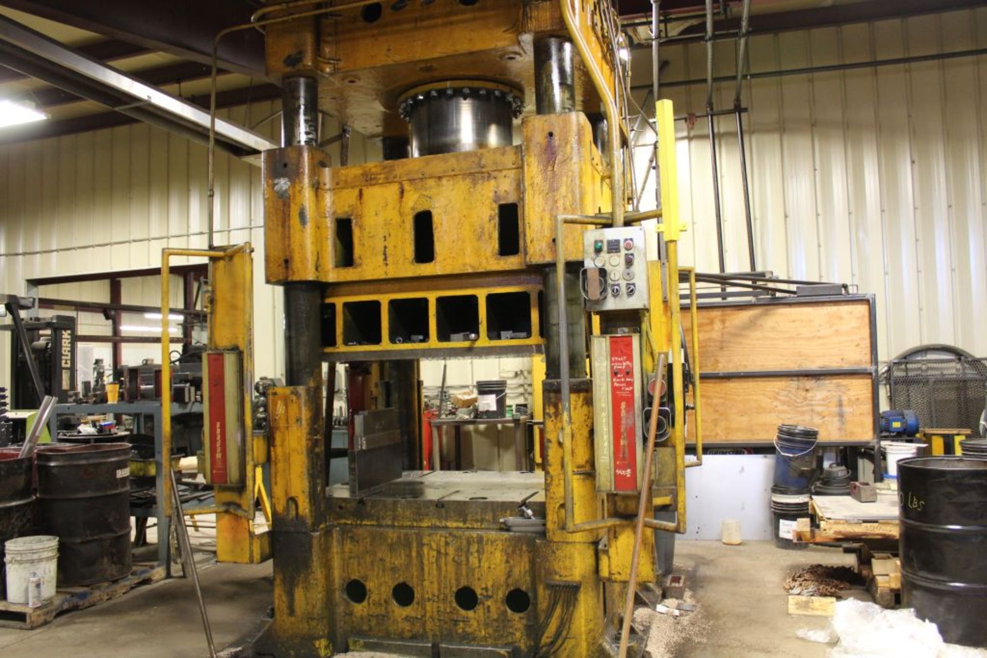 Elms hydraulic press, 600 T., 75 hp, 44 x 66" bed, 6' pit, safety curtain.