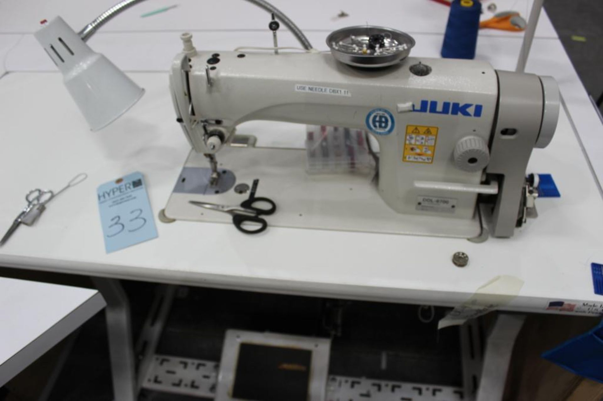 Juki model DDL-8700 sewing machine s/n 4D0KE11990 w/Sewing Table