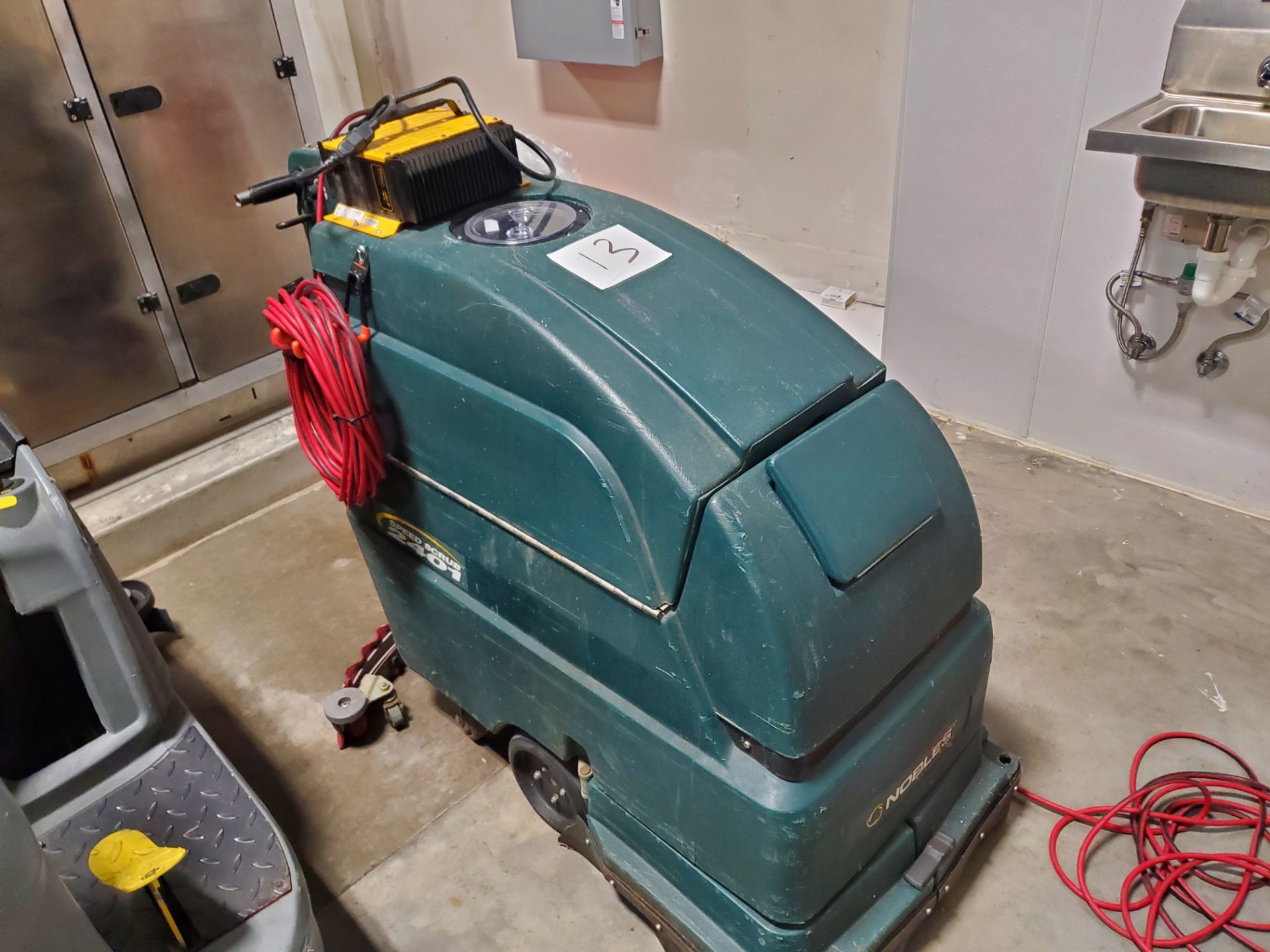 NOBLES Floor Scrubber, Model 2401,  Battery powered. Charger attached to machine NOTE Said to only