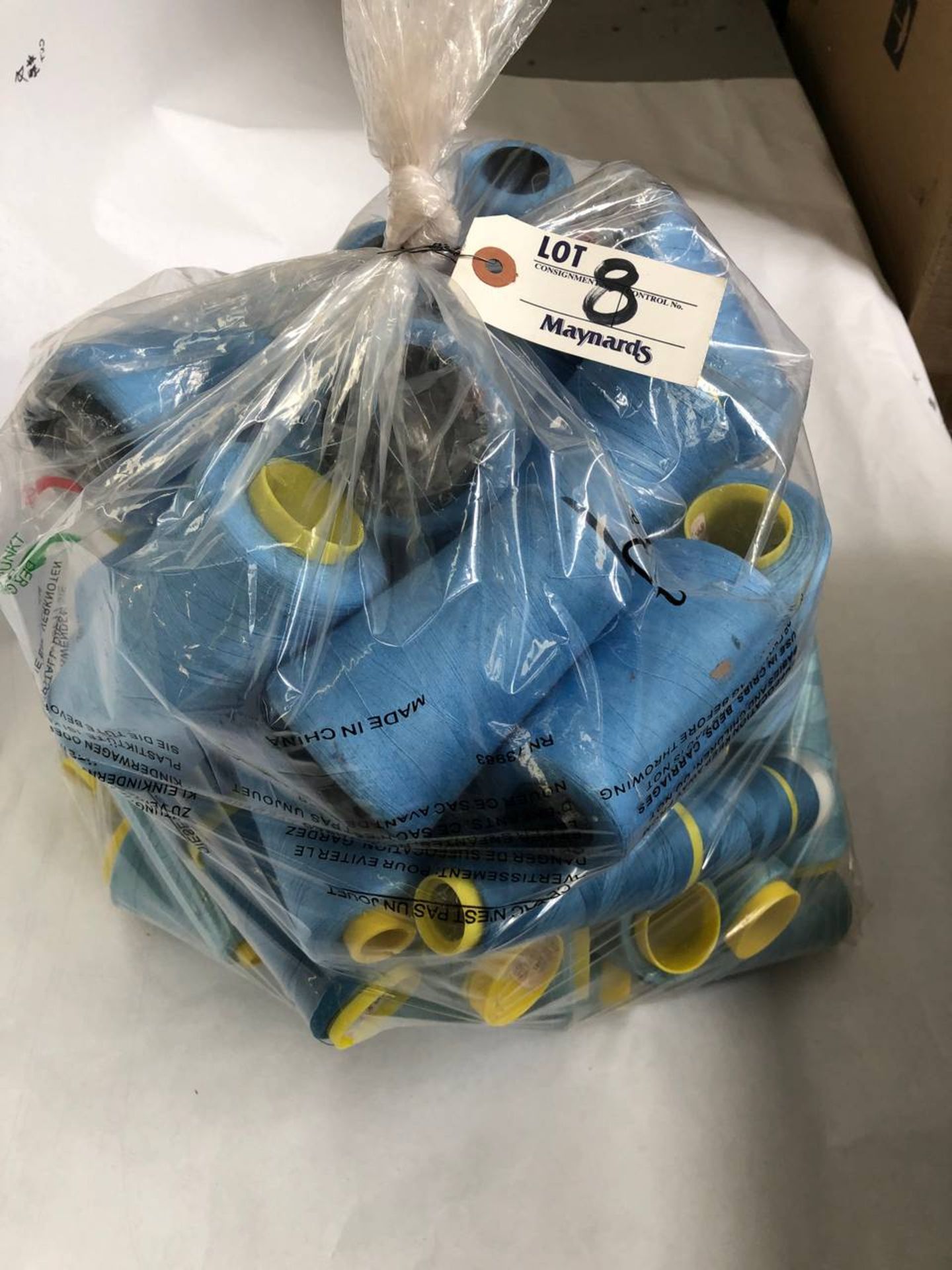 Bag of assorted sky blue colored thread rolls