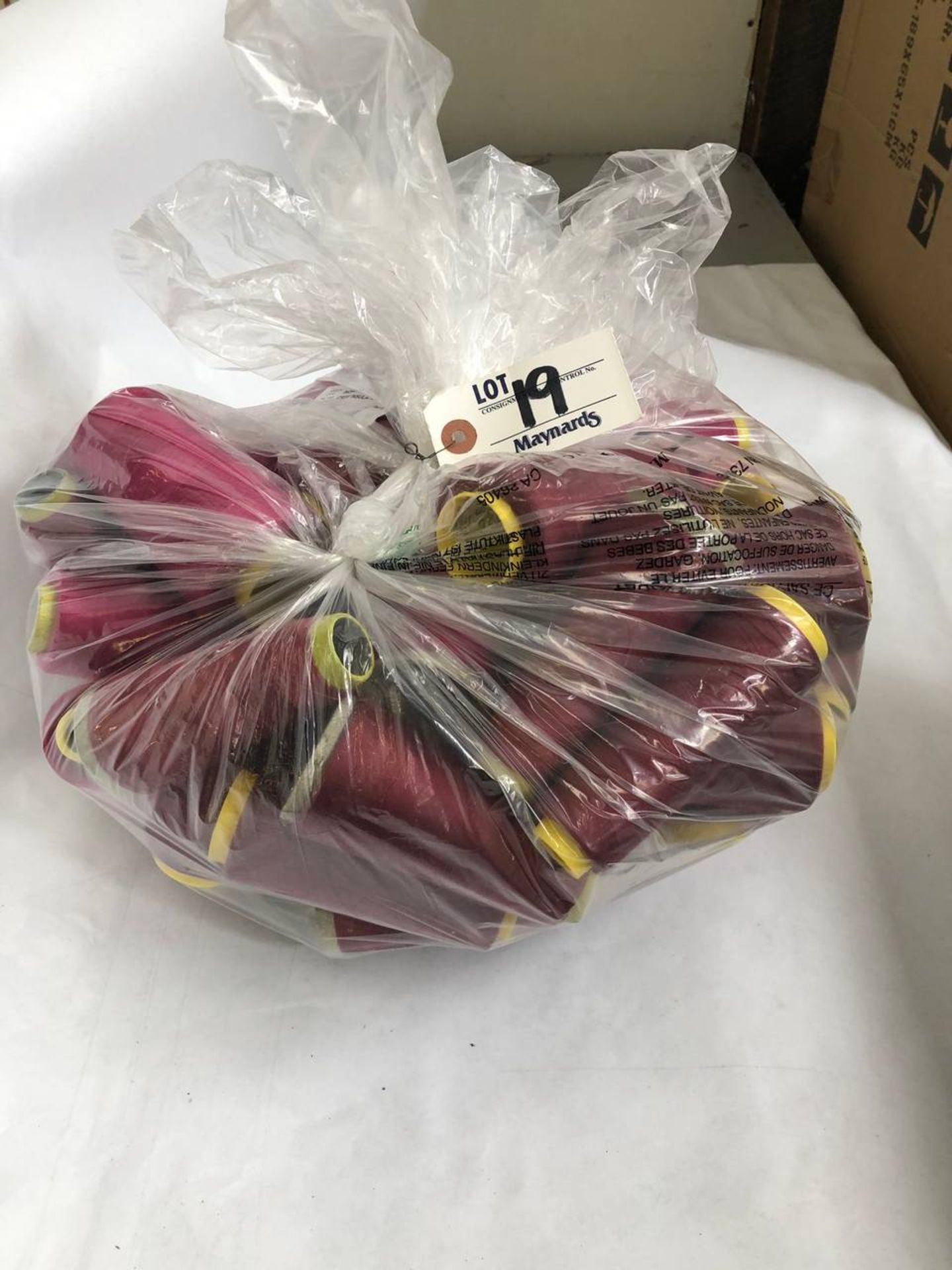 Bag of assorted burgundy colored thread rolls