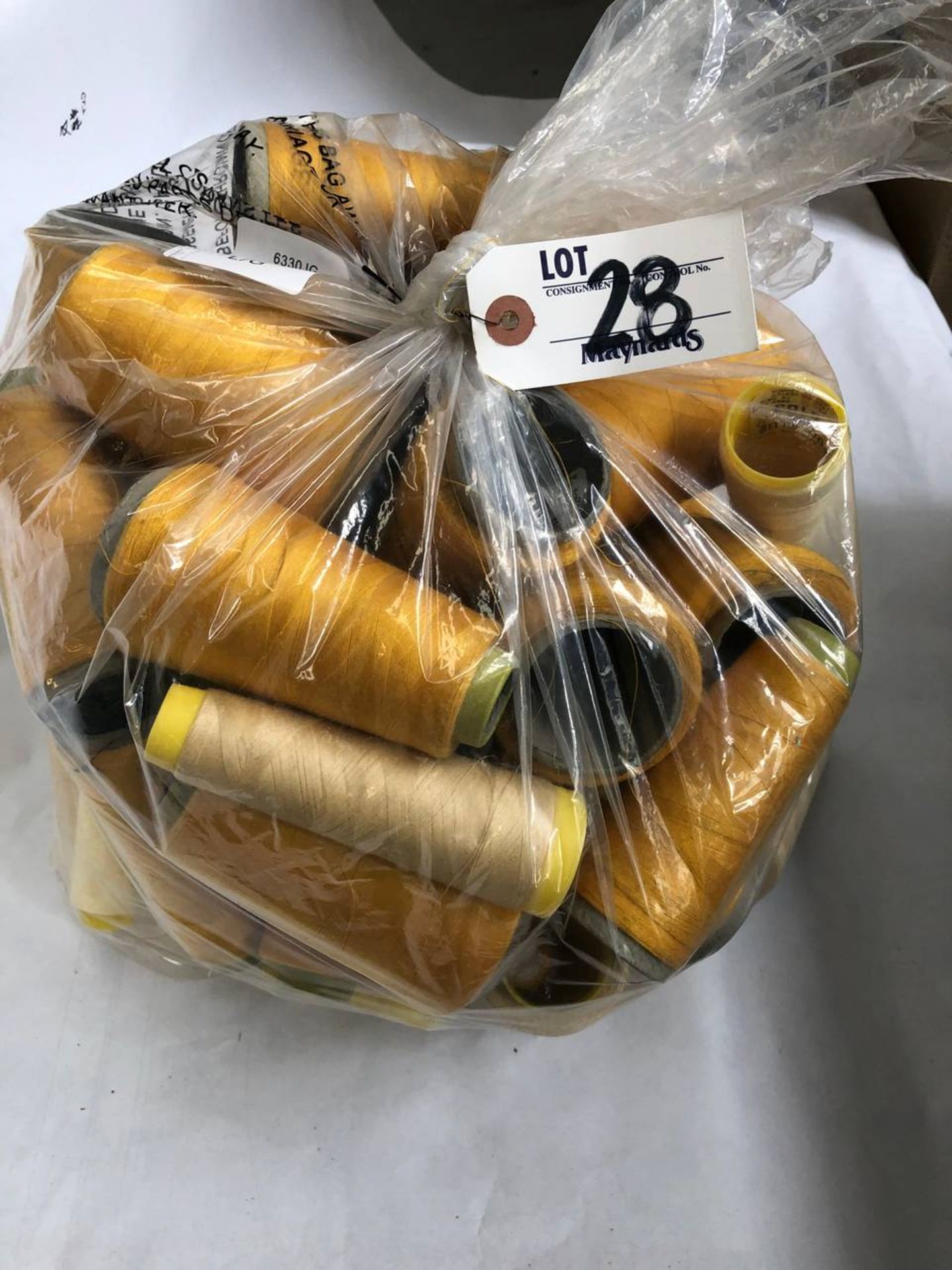 Bag of assorted golden colored thread rolls