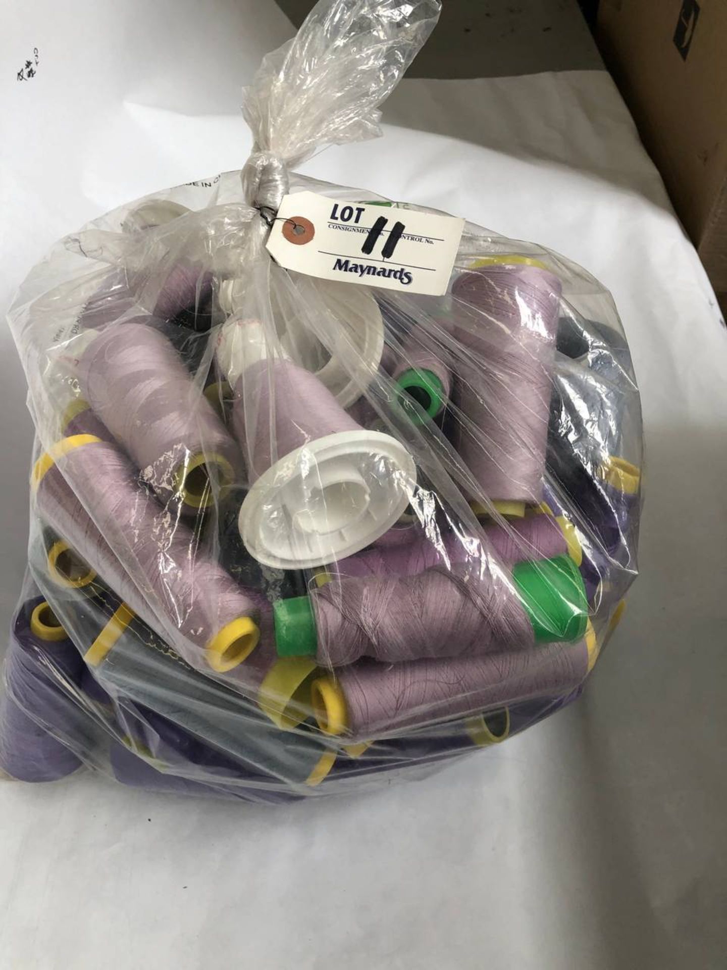 Bag of assorted lilac colored thread rolls