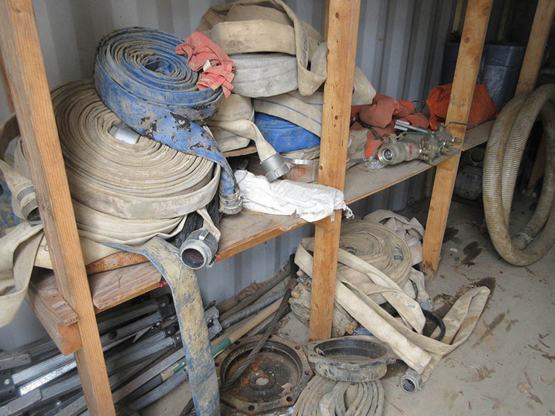 CONTENTS OF CONTAINER - ASSORTED DISCHARGE HOSE, TORCH HOSES, DRILL, AND FISH TAPE SPOOL
