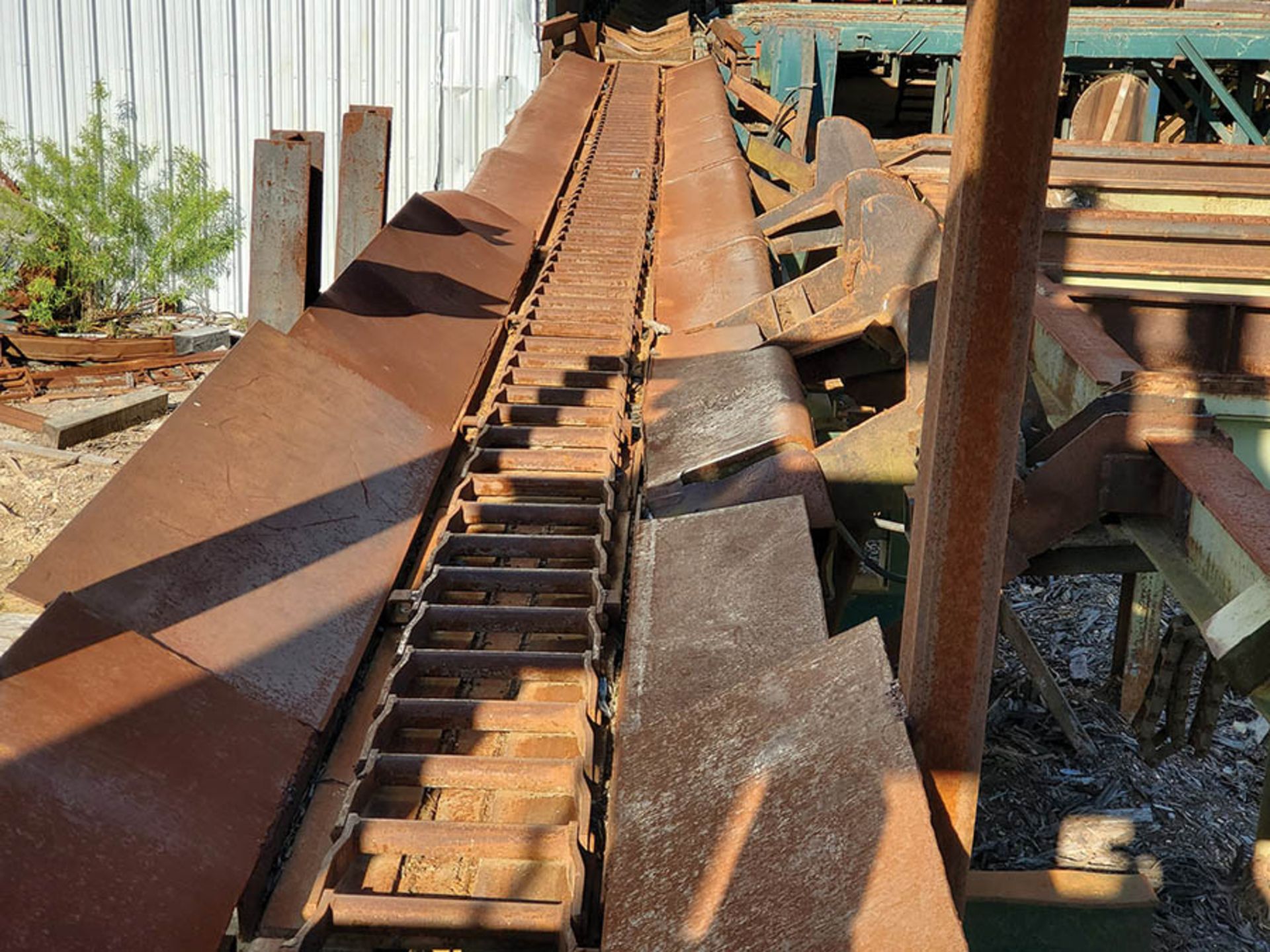 INFEED LOG TROUGH CONVEYOR INTO MILL STRAND SINGLE OF H-82 CHAIN, 4 TONG LOG PICKER ONTO 3 STRAND