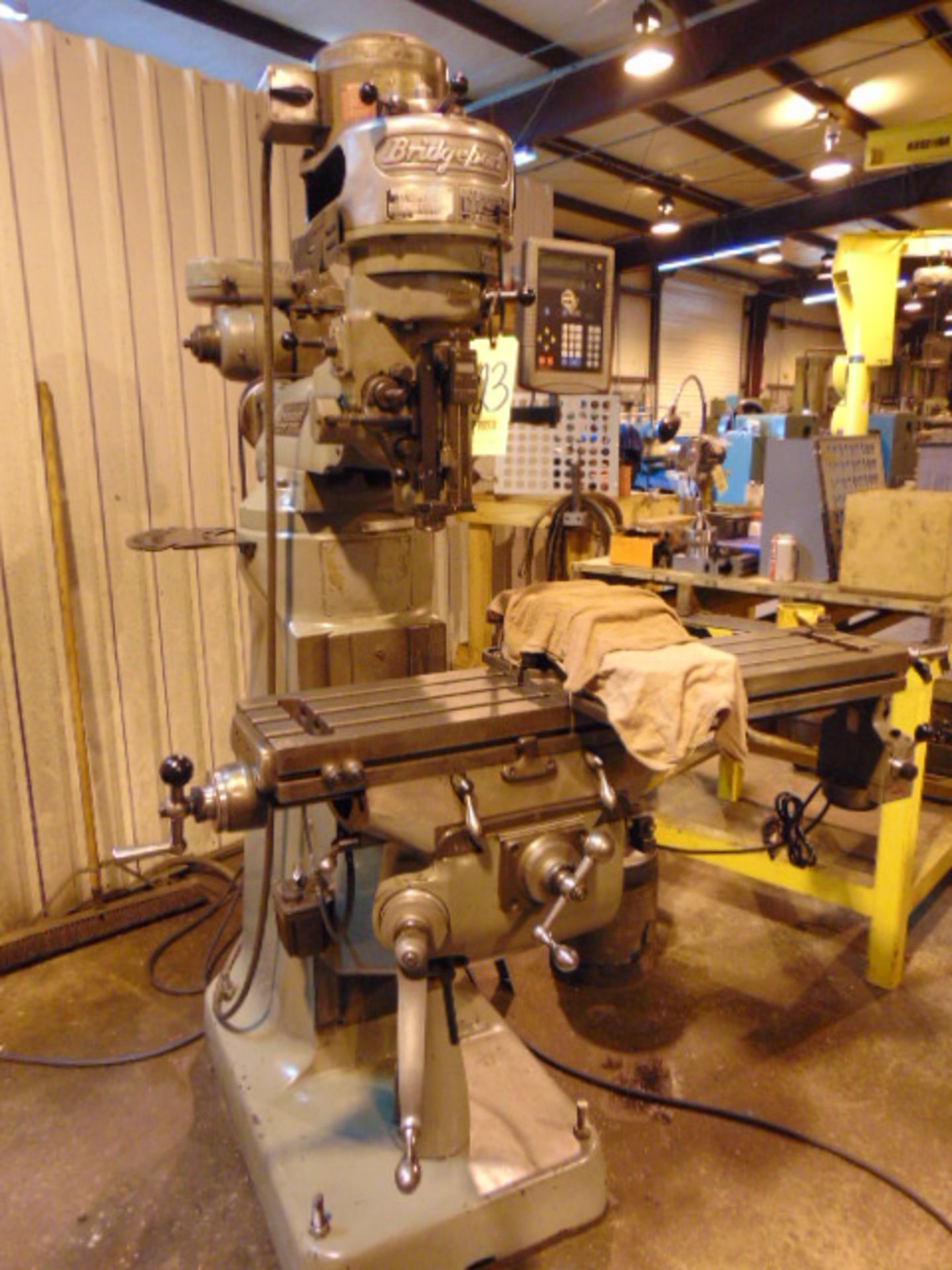 VERTICAL TURRET MILL, BRIDGEPORT J-HEAD, 9” x 42” table, 1 HP step pulley head, Newall 2-axis D.R.