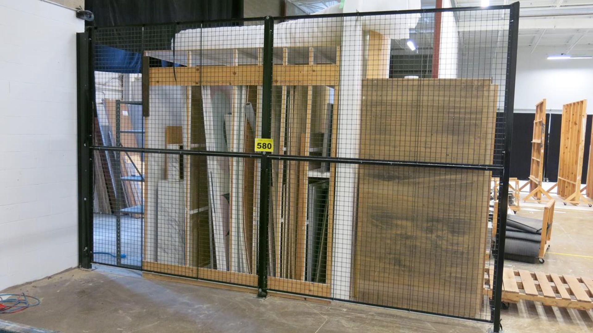 BLACK METAL DIVIDING WALL WITH (2) BLACK ROLLING ACCESS GATES, 640' LONG, 10' HIGH (COMPRISED OF (