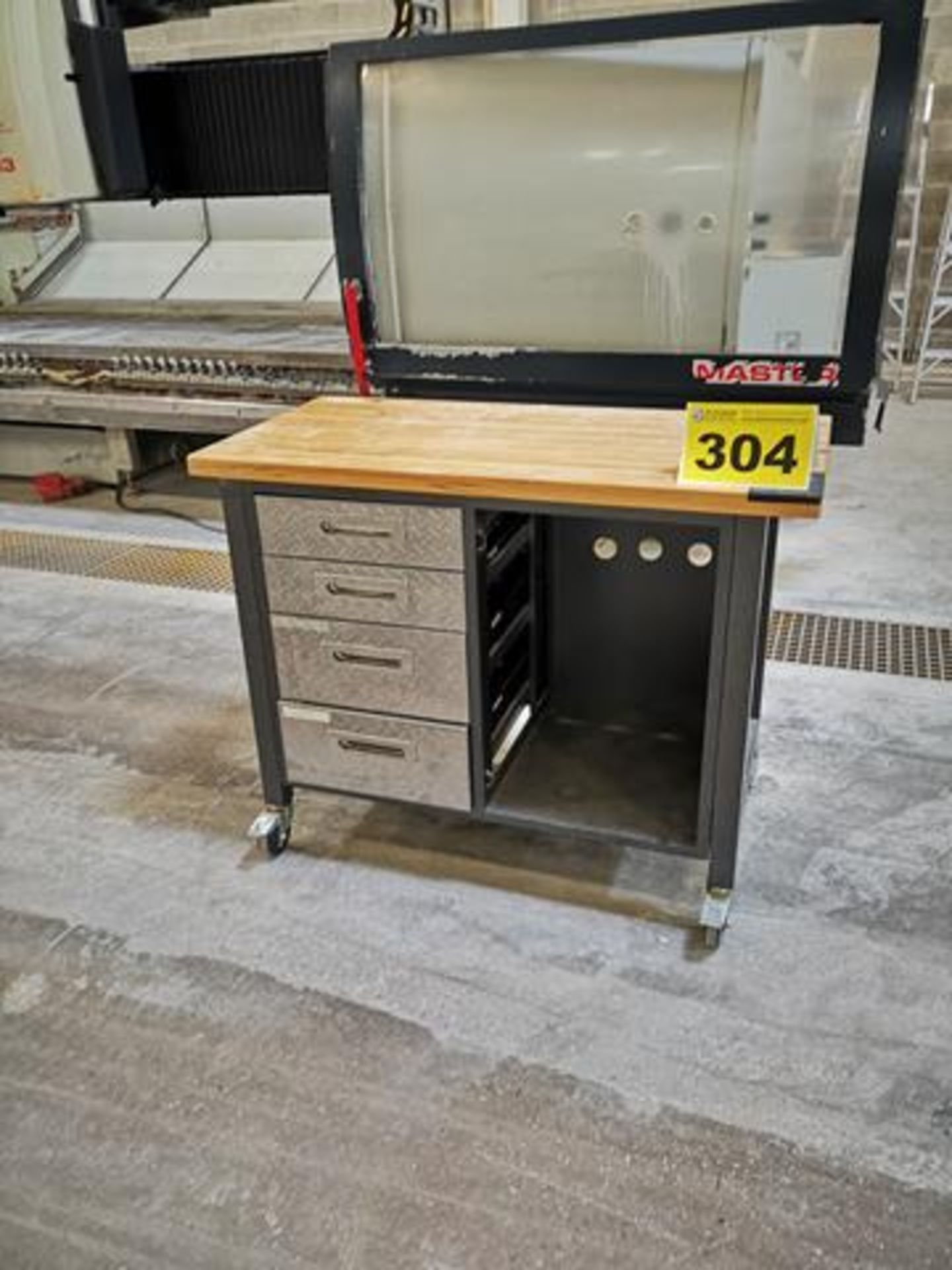 METAL WORKBENCH, WITH WOOD TOP AND 4 DRAWERS ON CASTERS